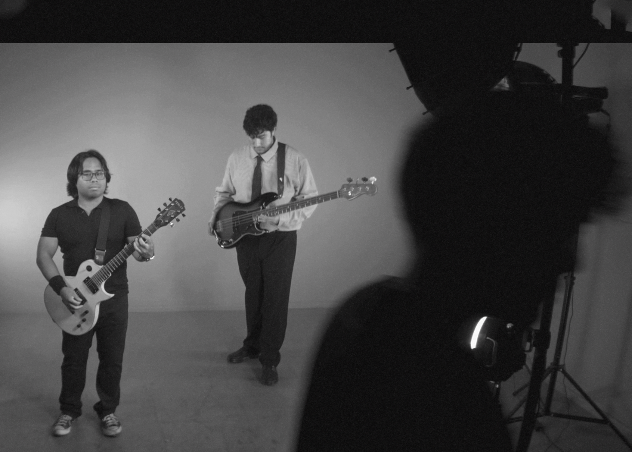 a black and white photo of a group of people standing in front of a camera