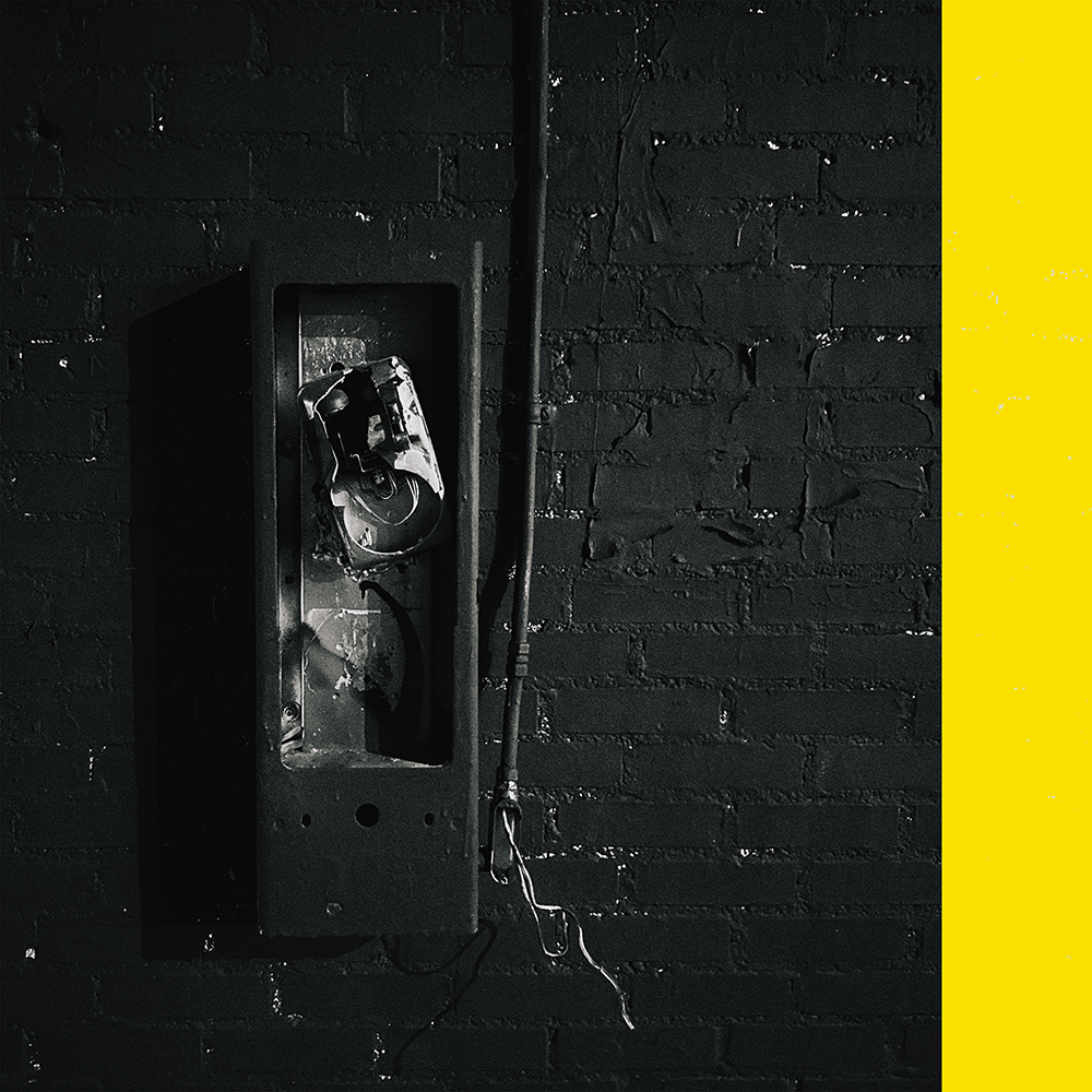 a brick wall with a telephone on it