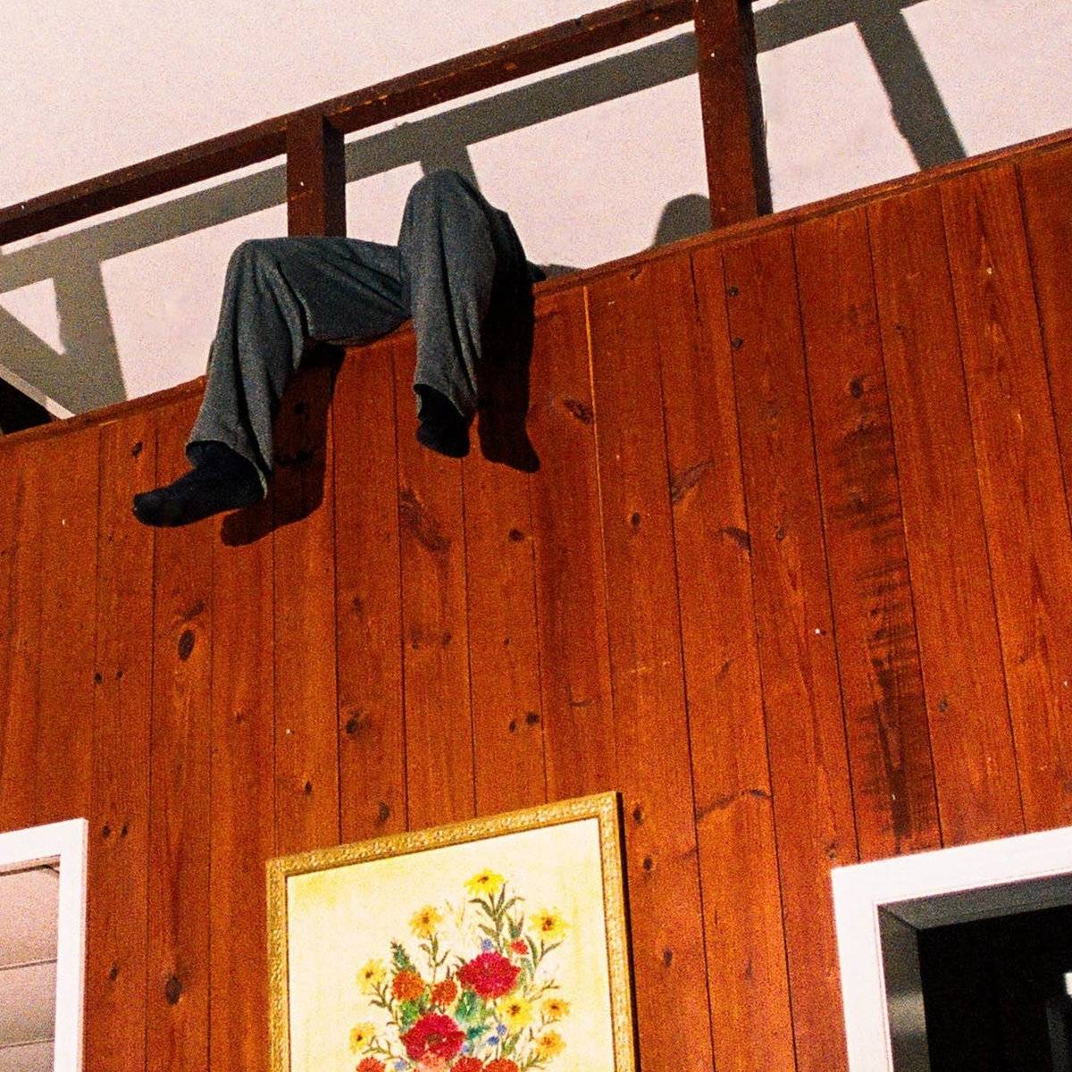 a man is hanging from the ceiling of a room
