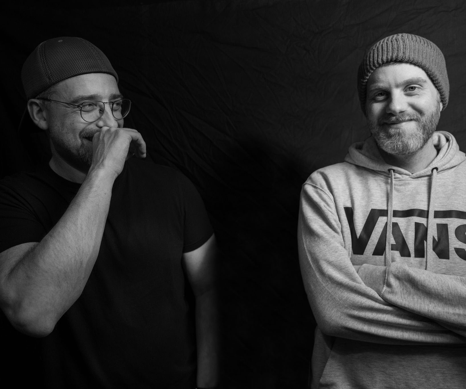 two men in black and white standing next to each other