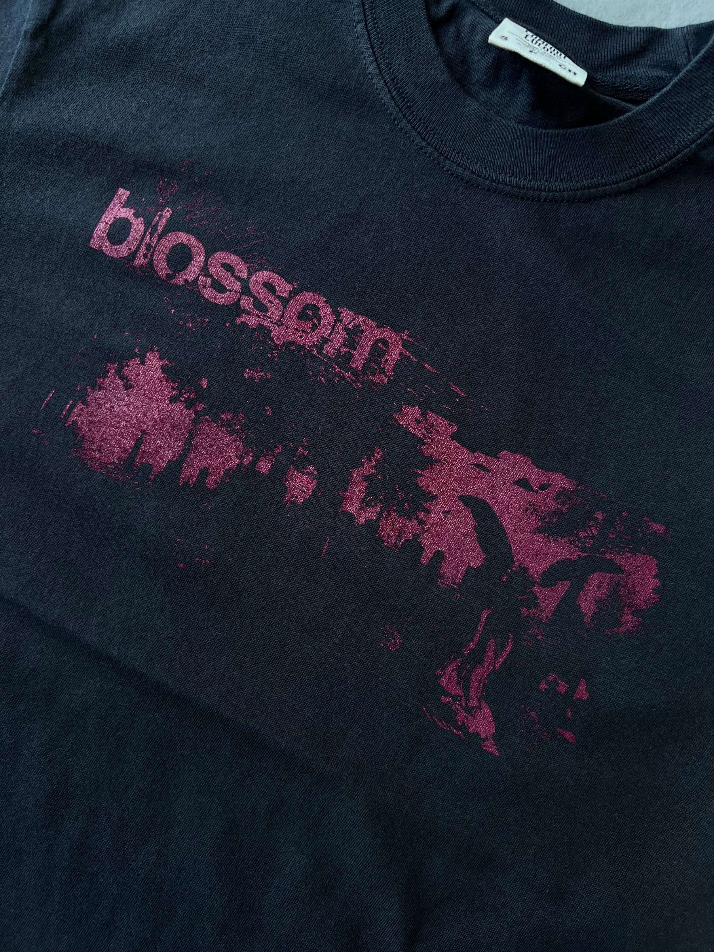 a black t - shirt with the word bloom on it