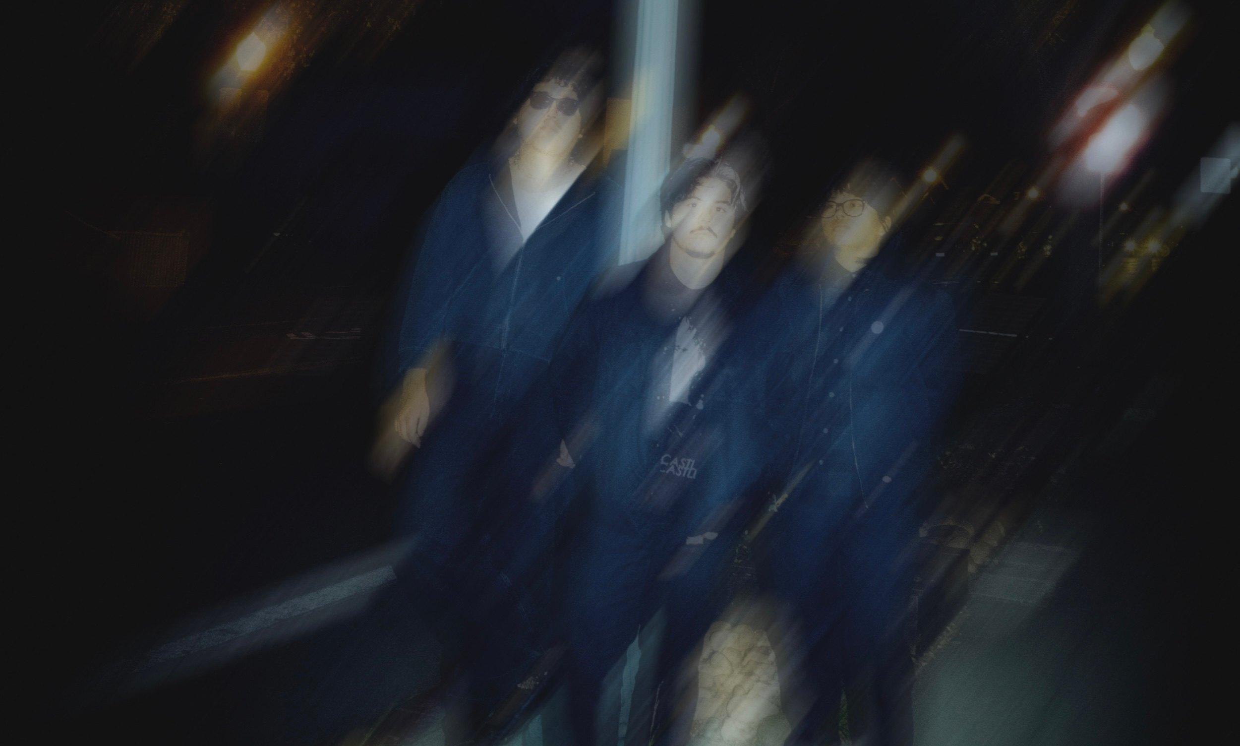 a blurry image of a group of people standing on a street