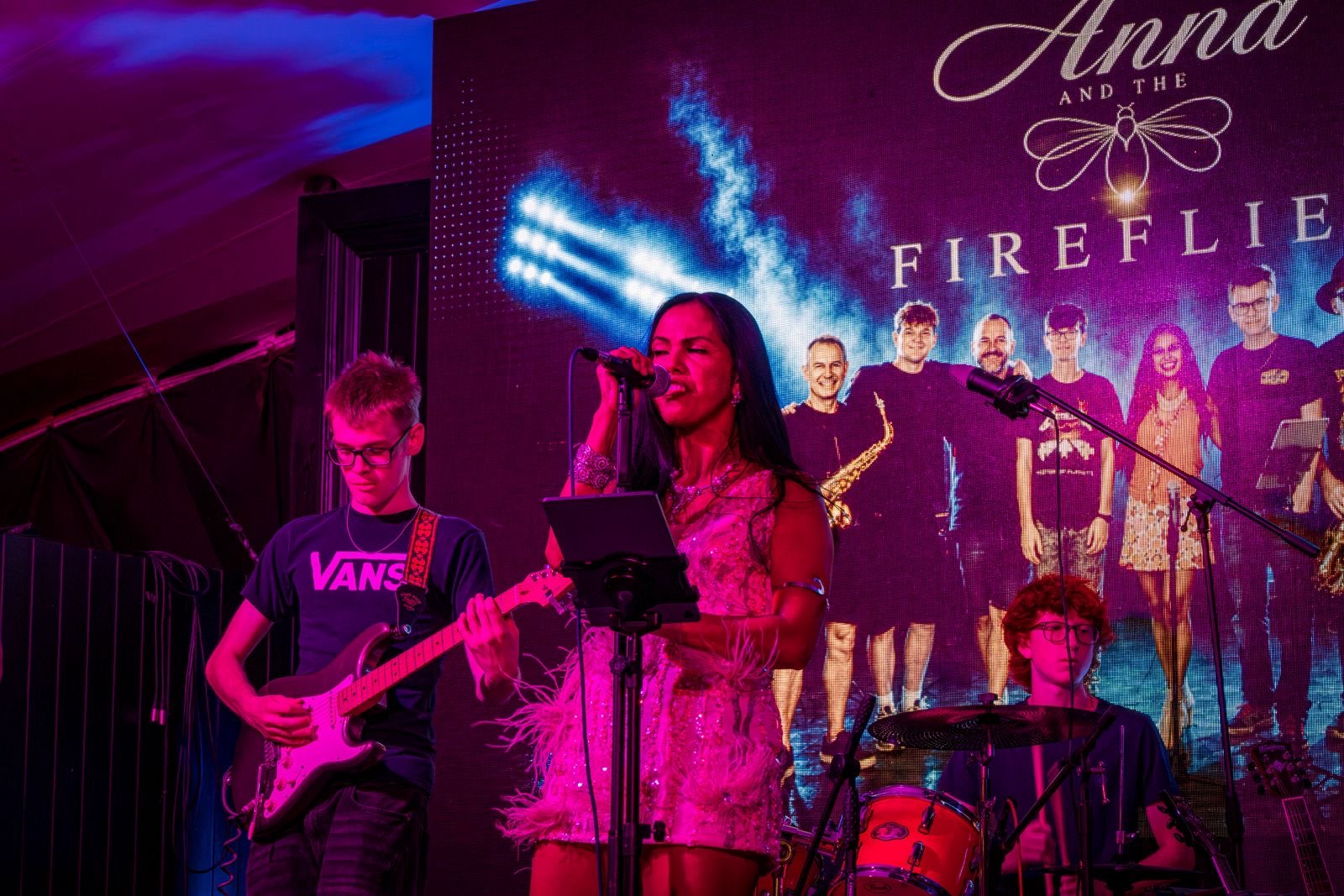 a group of people on stage at a concert