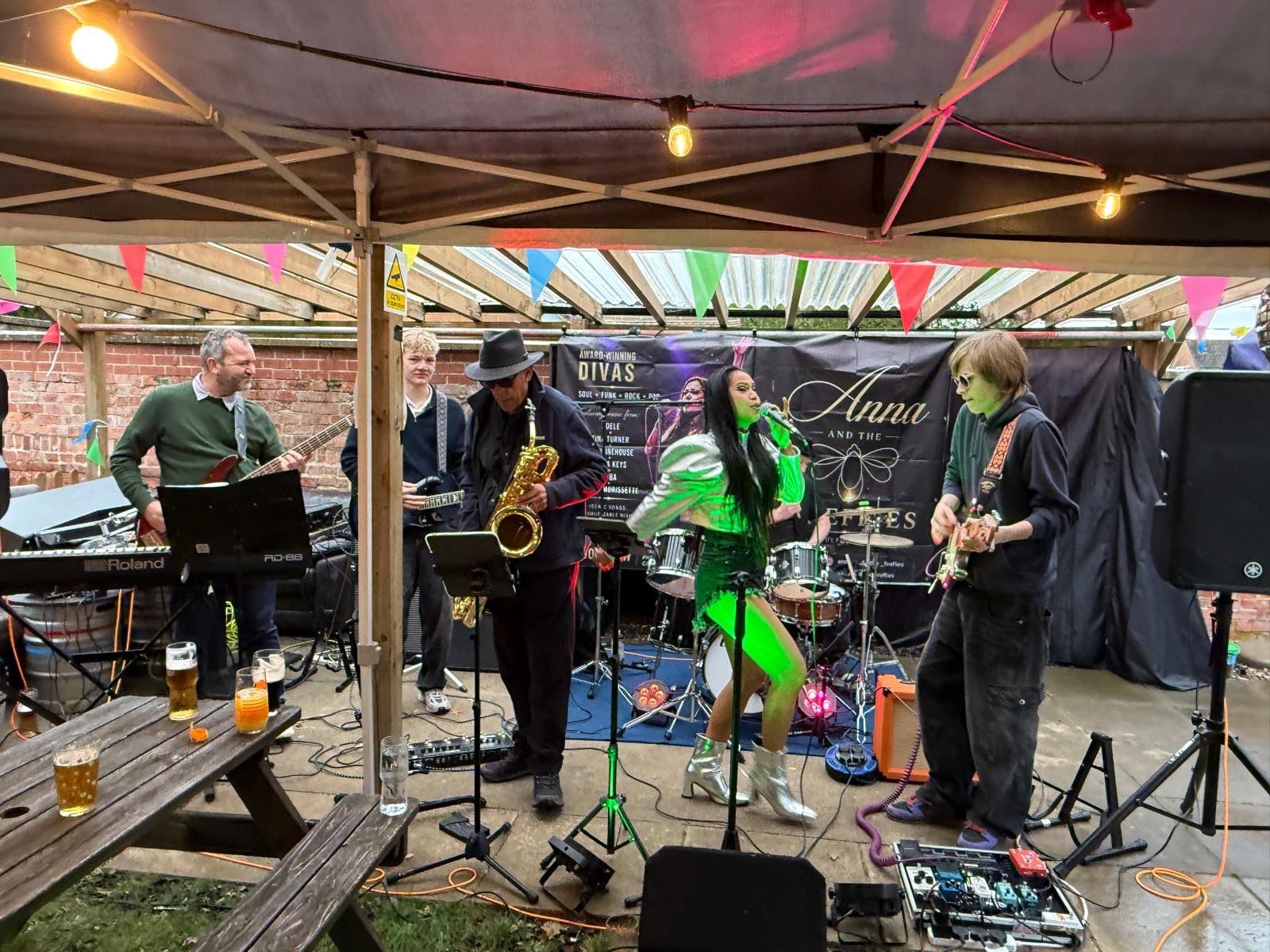 a group of people playing music under a tent