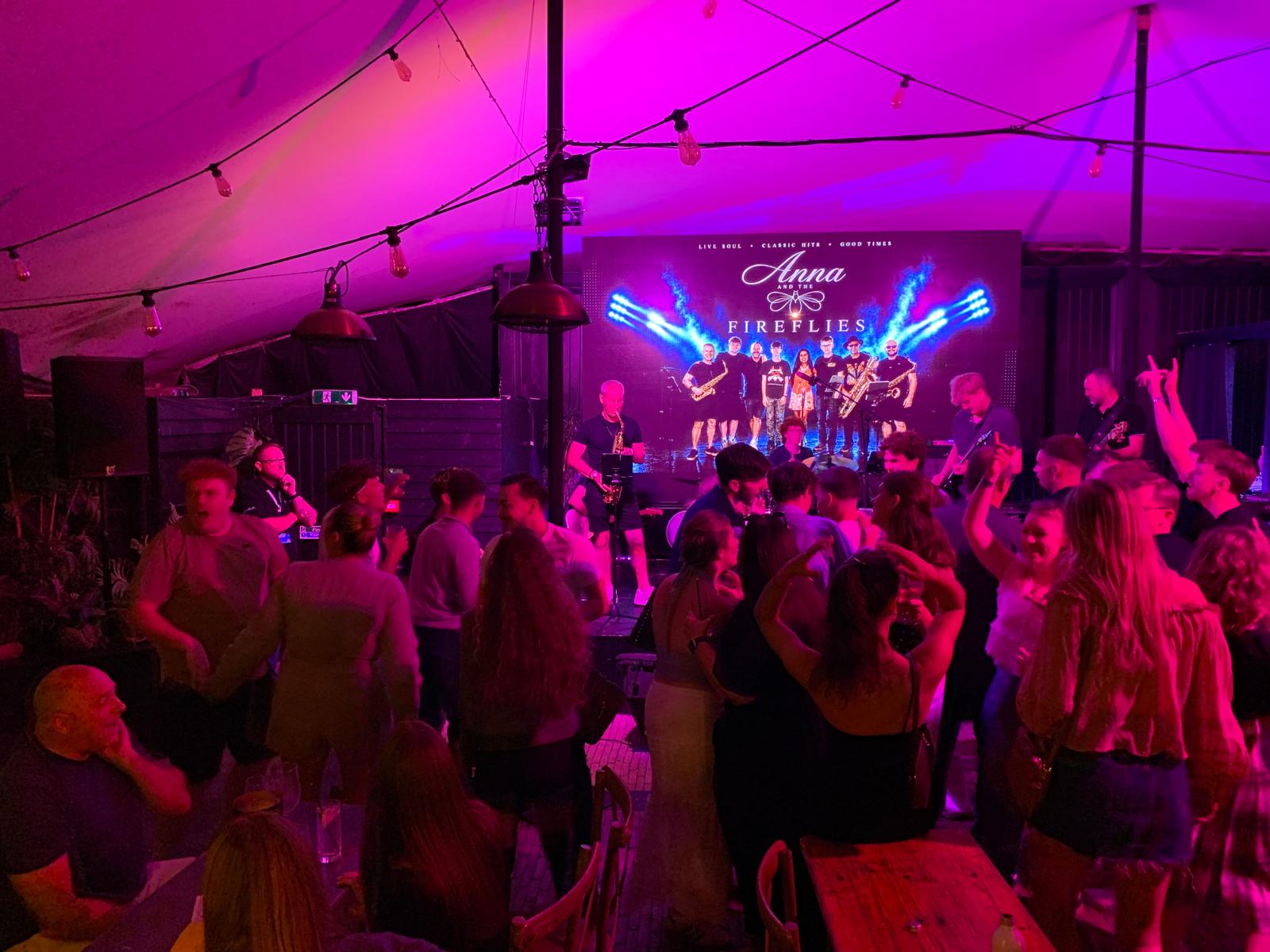 a group of people at a party in a tent