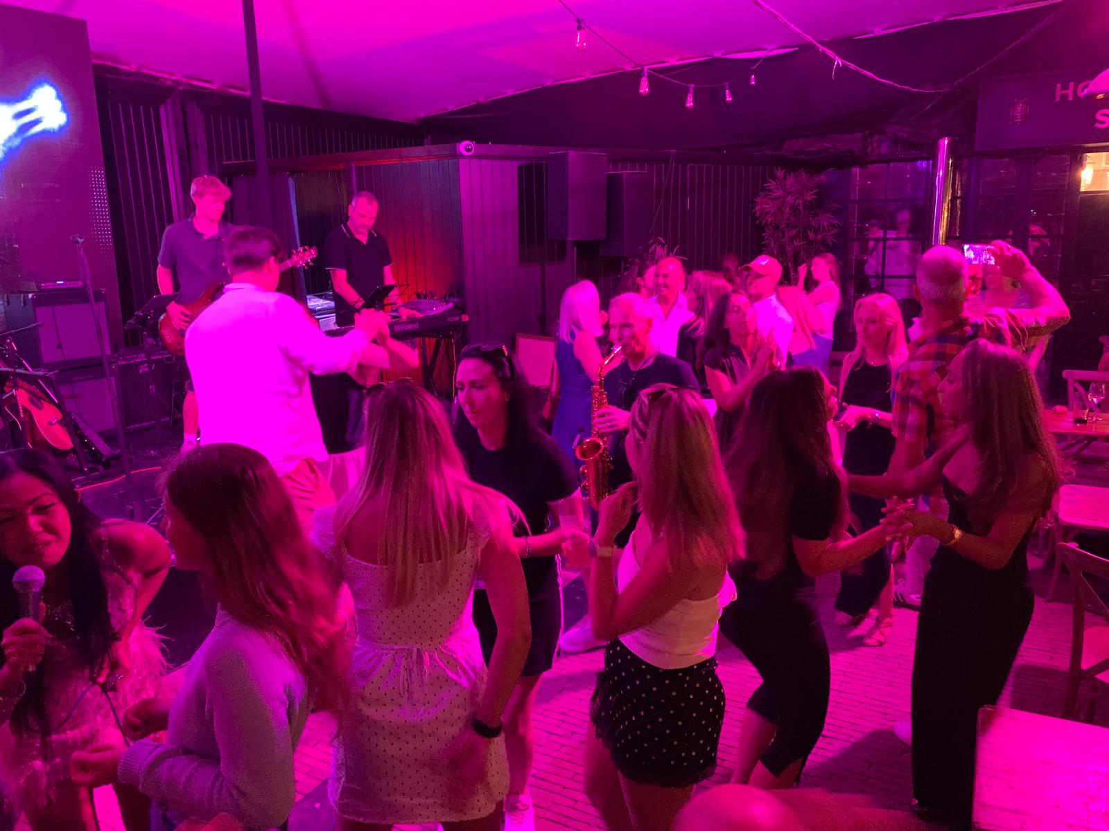 a group of people dancing at a nightclub