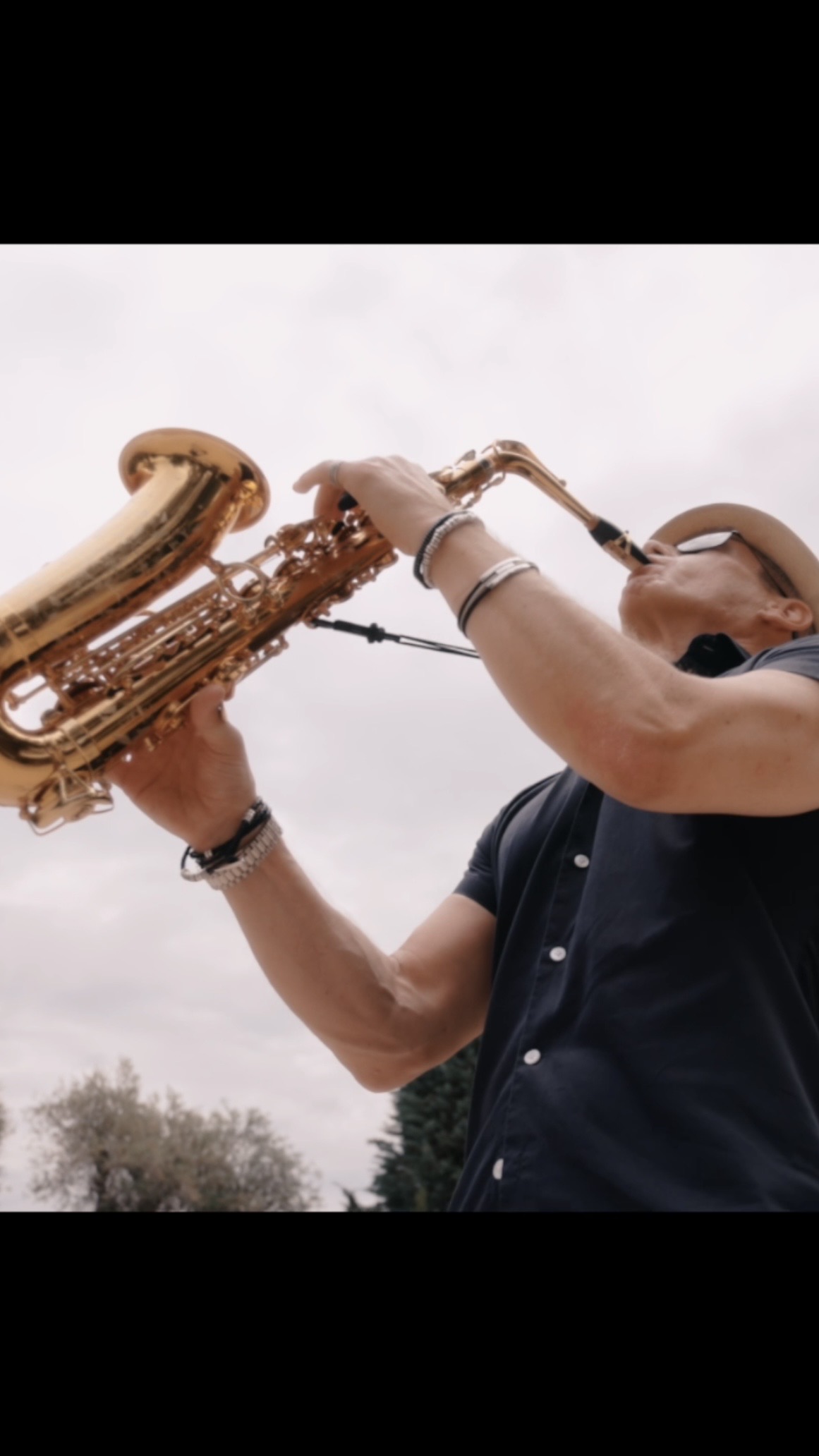 a man playing a saxophone outdoors