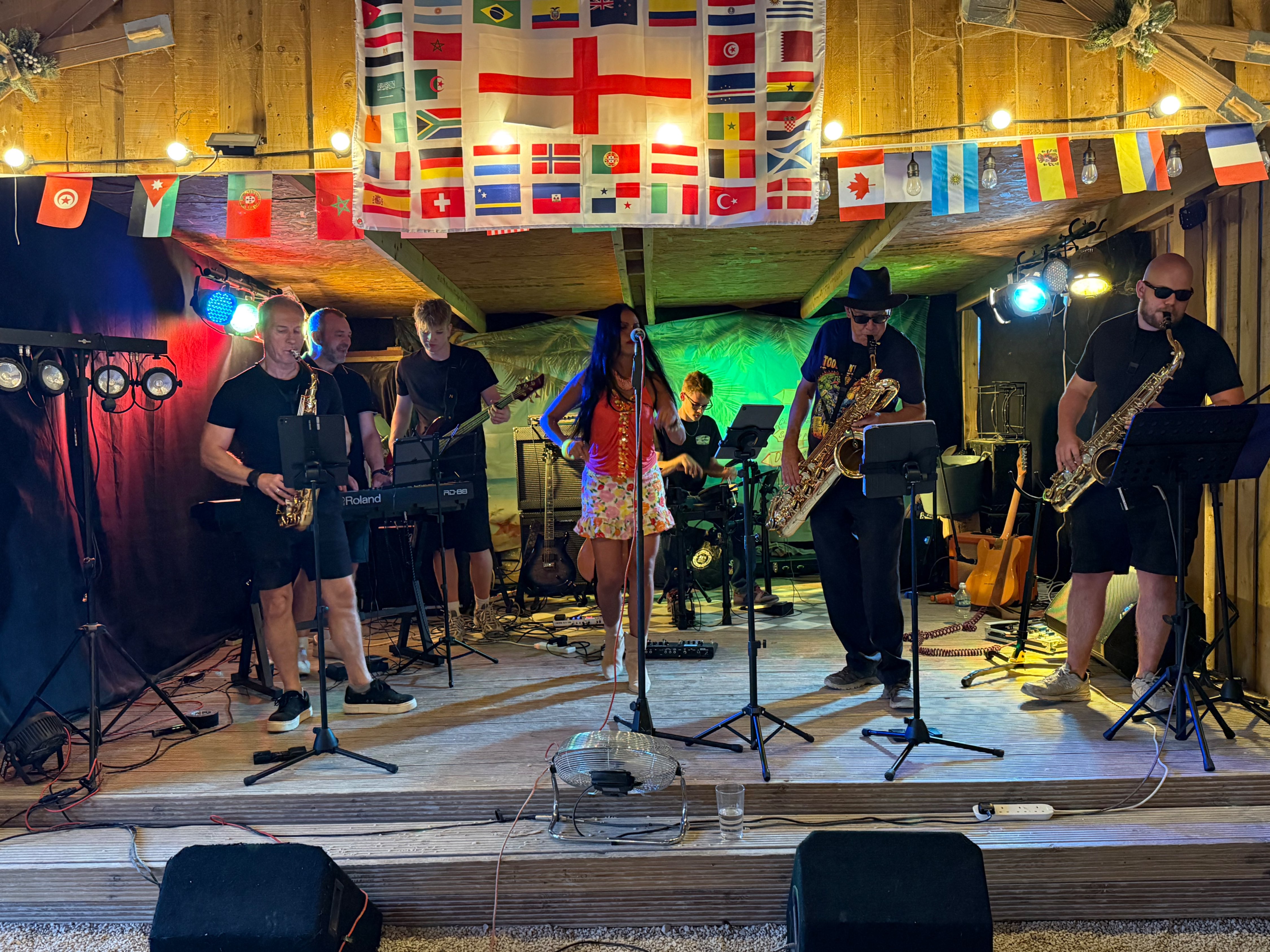 a group of people playing music in a barn