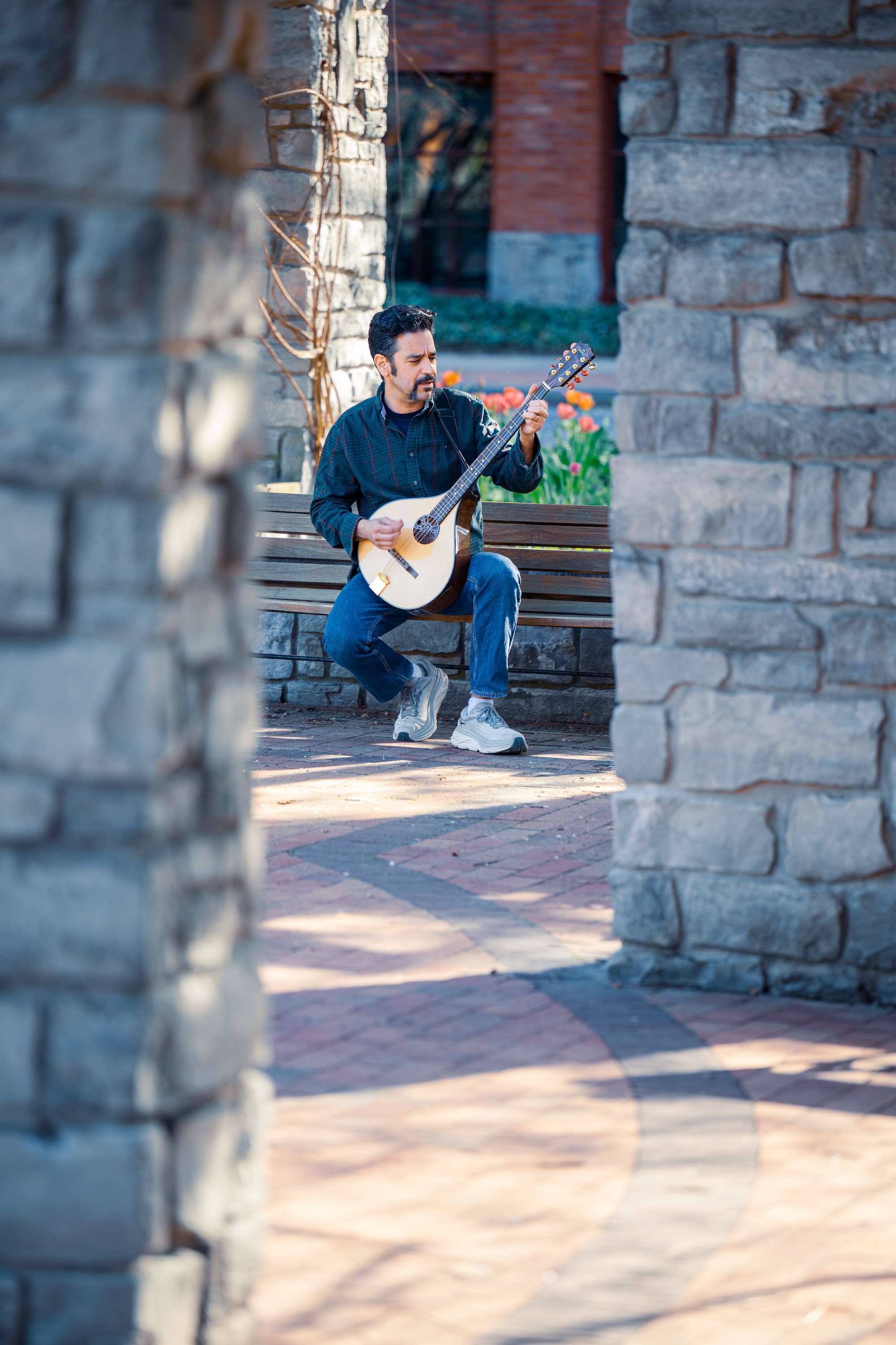 a man playing a guitar in a park