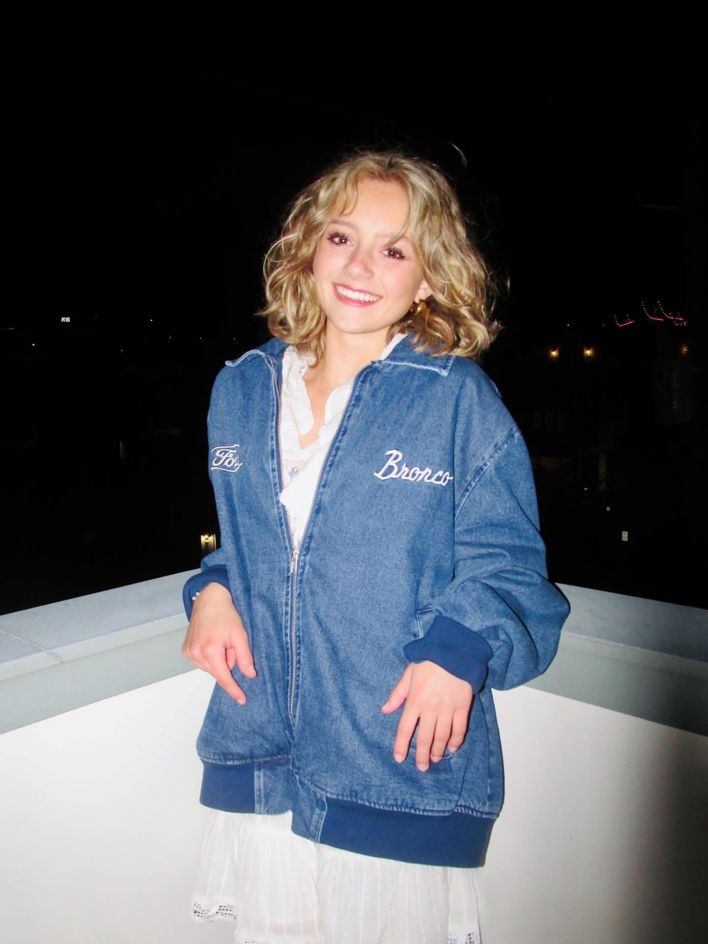 a girl wearing a denim jacket