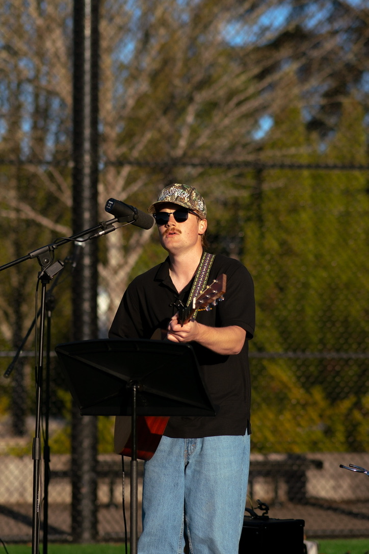 a man playing an acoustic guitar