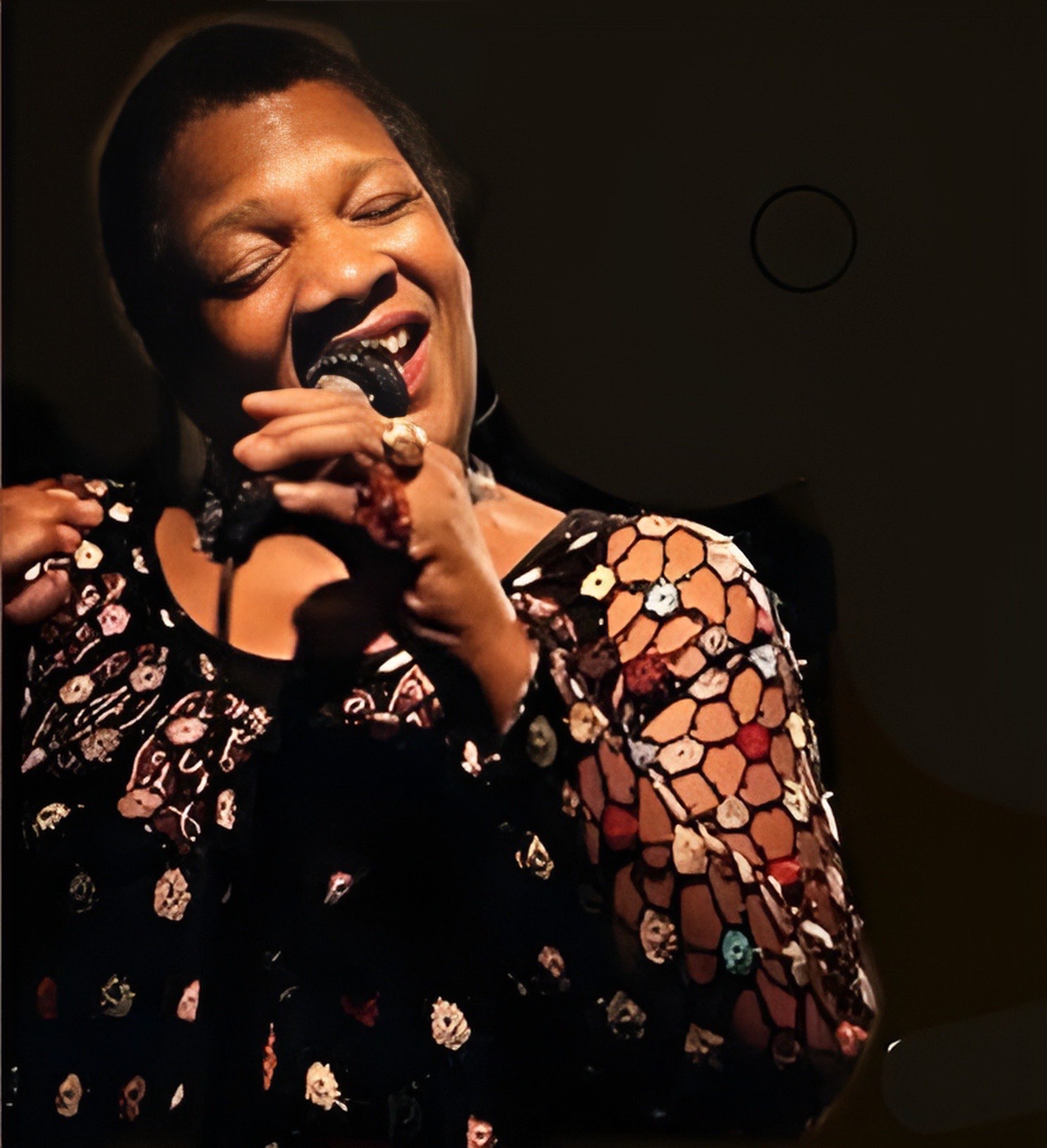 a woman singing into a microphone