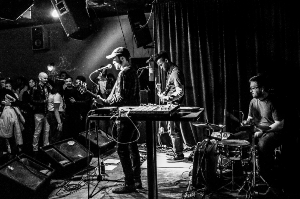 a black and white photo of a band on stage