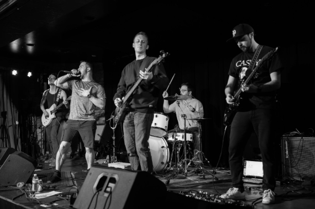 a black and white photo of a band on stage