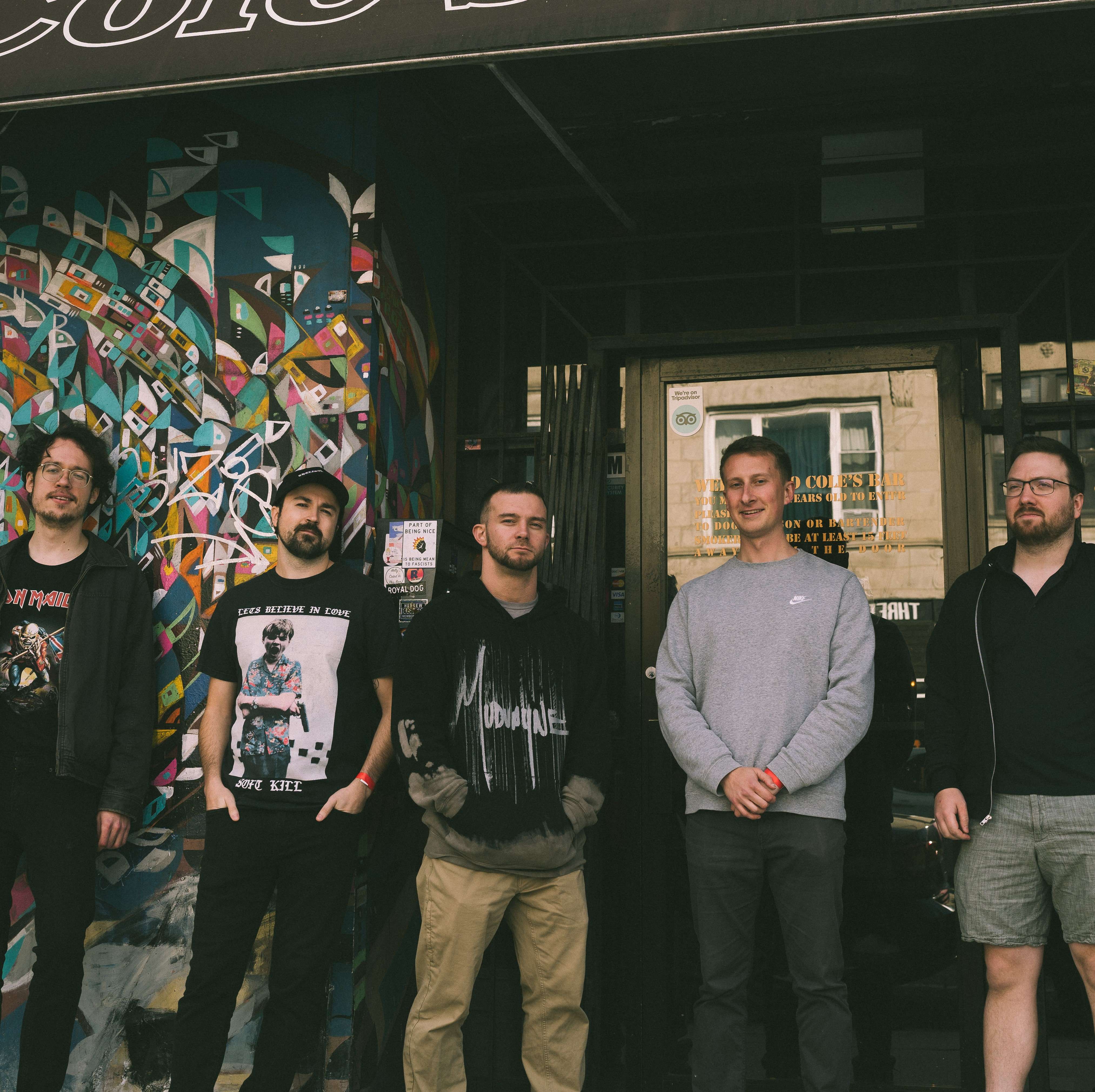 a group of men standing in front of a building