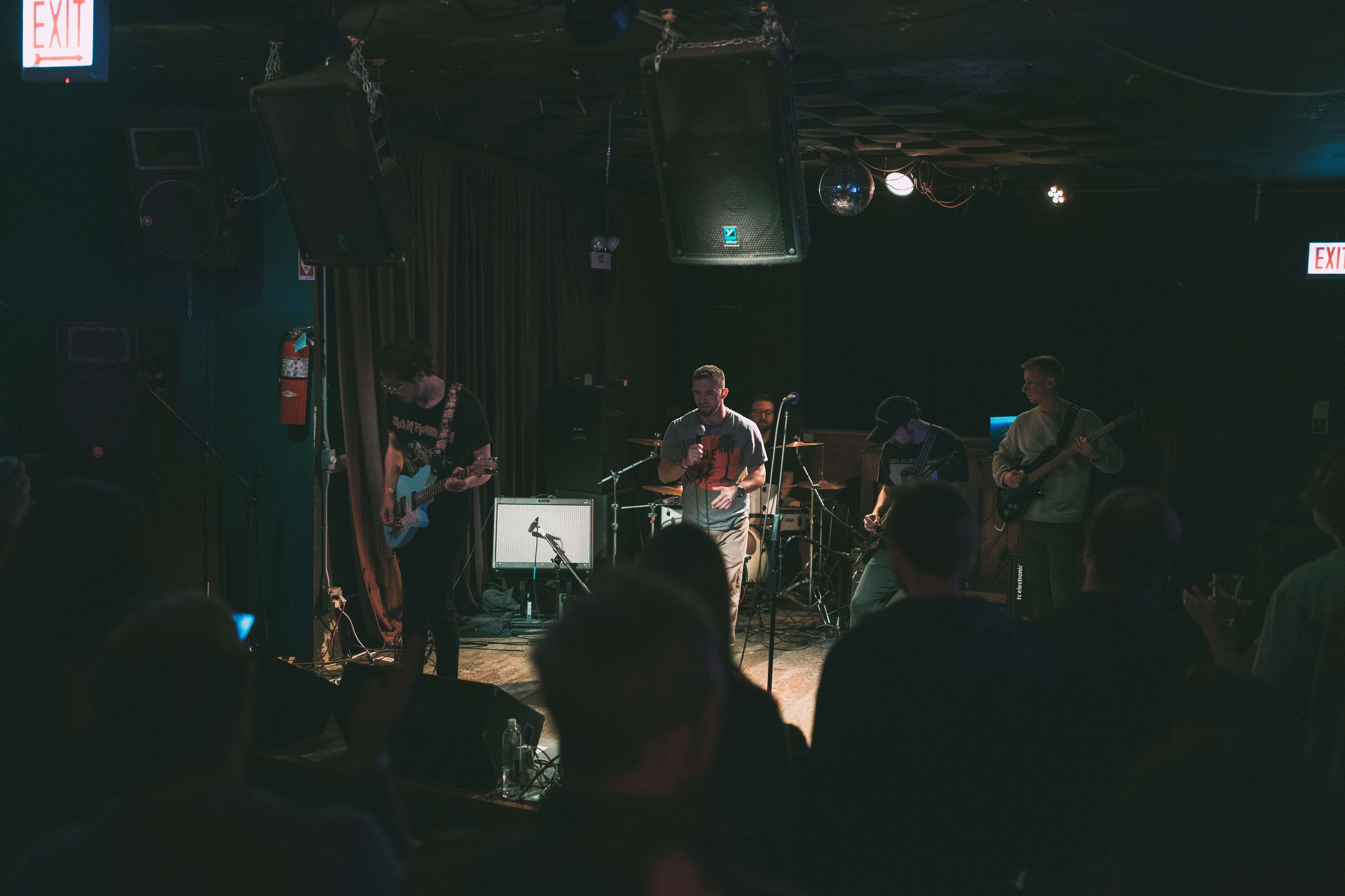 a group of people on stage in a dark room