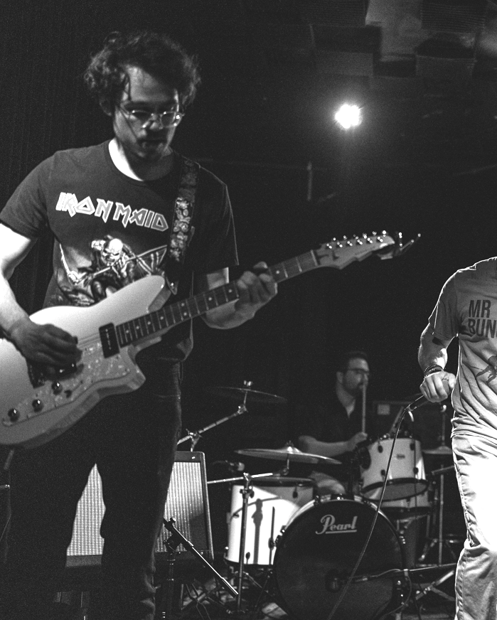 a black and white photo of a group of people playing a musical instrument
