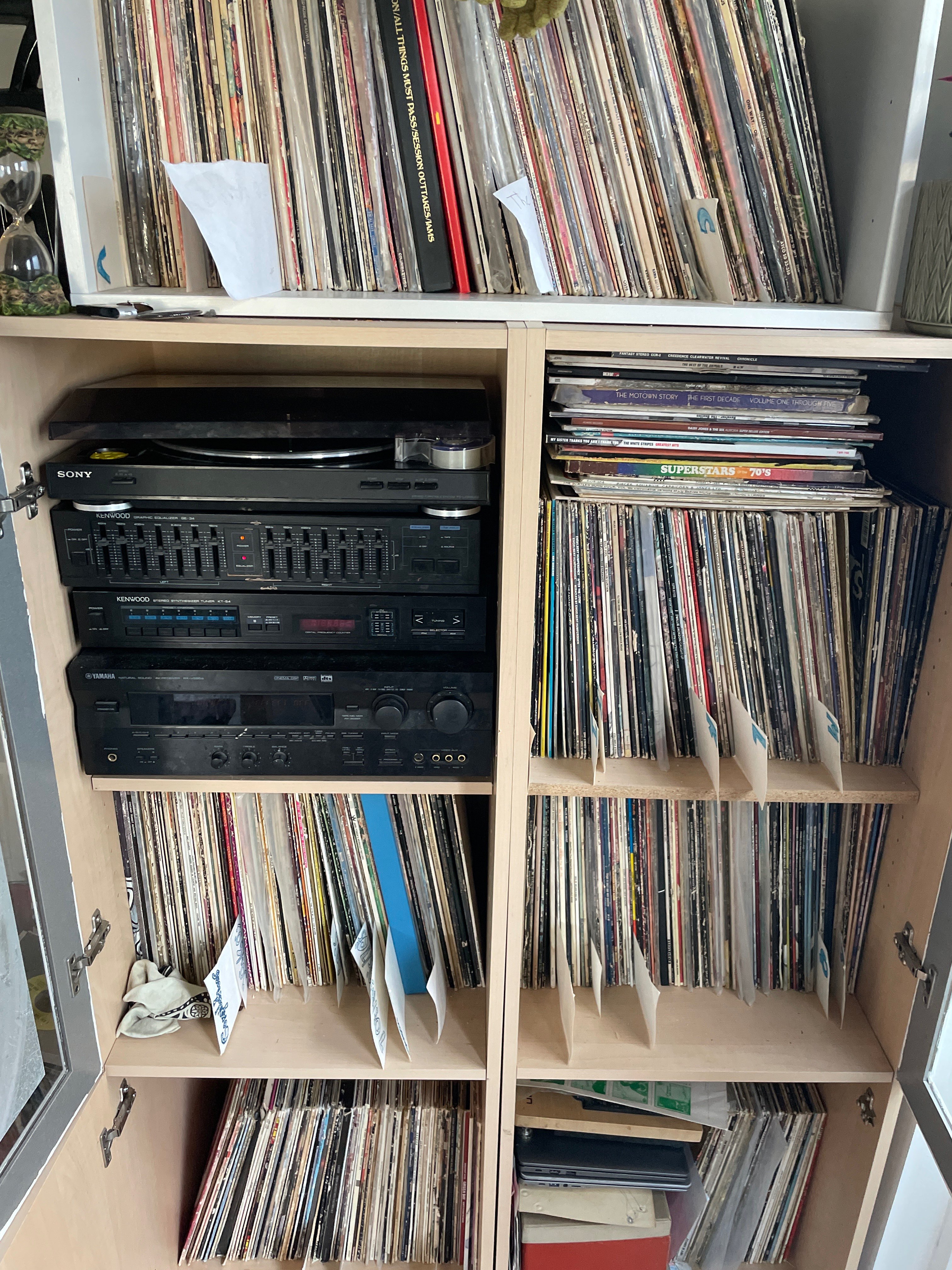 a wooden cabinet with a lot of records in it