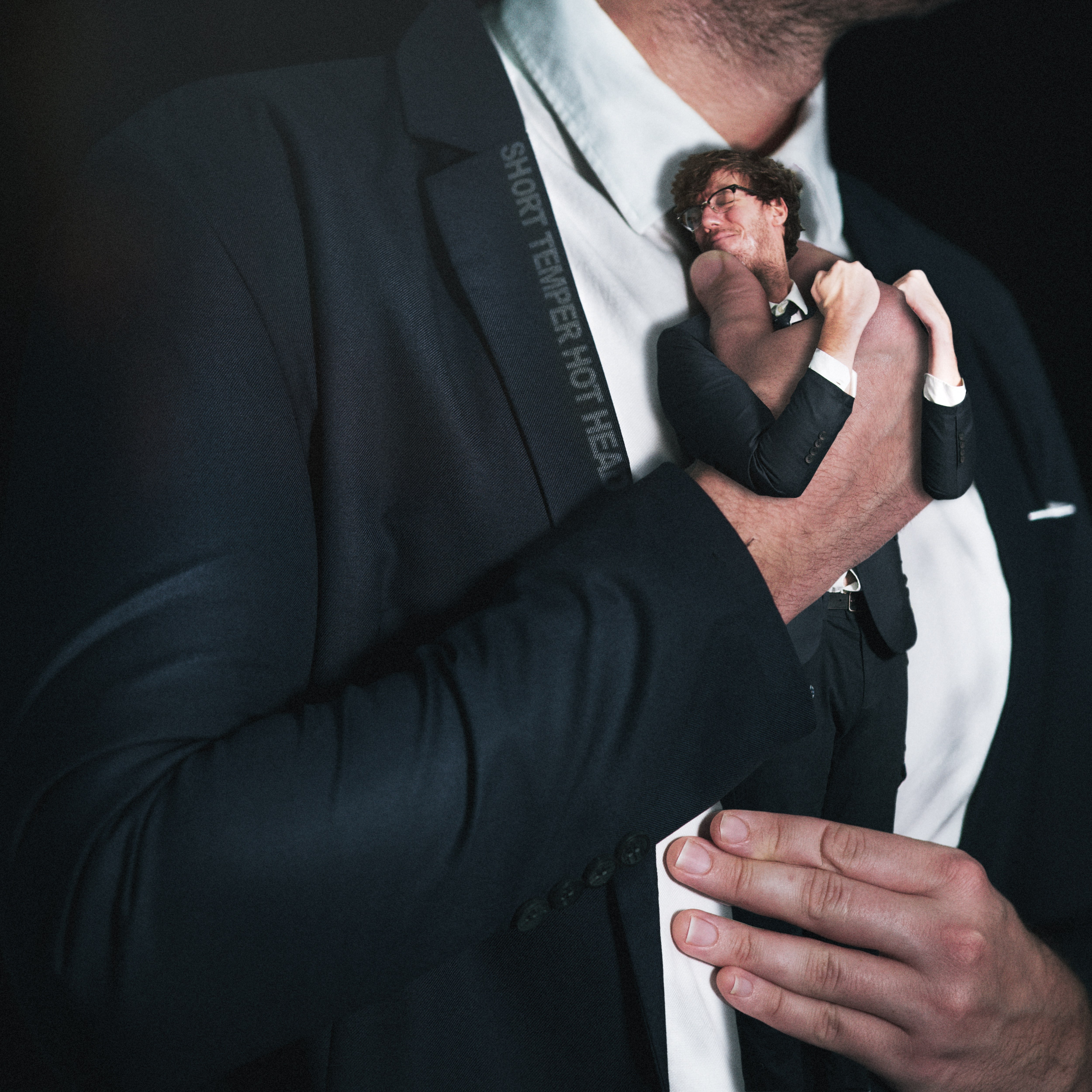 a man in a suit holding a doll