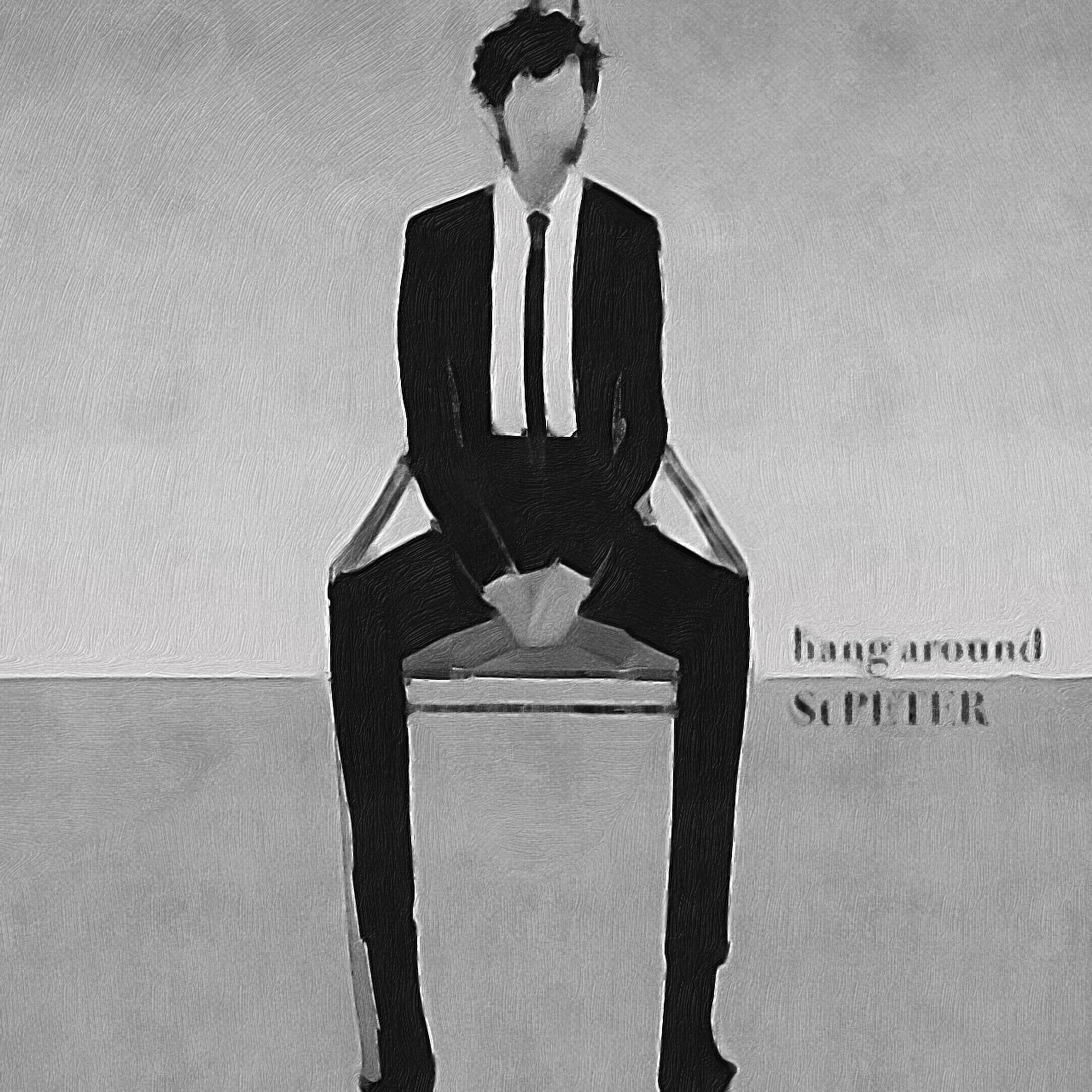 a man in a suit sits on a chair