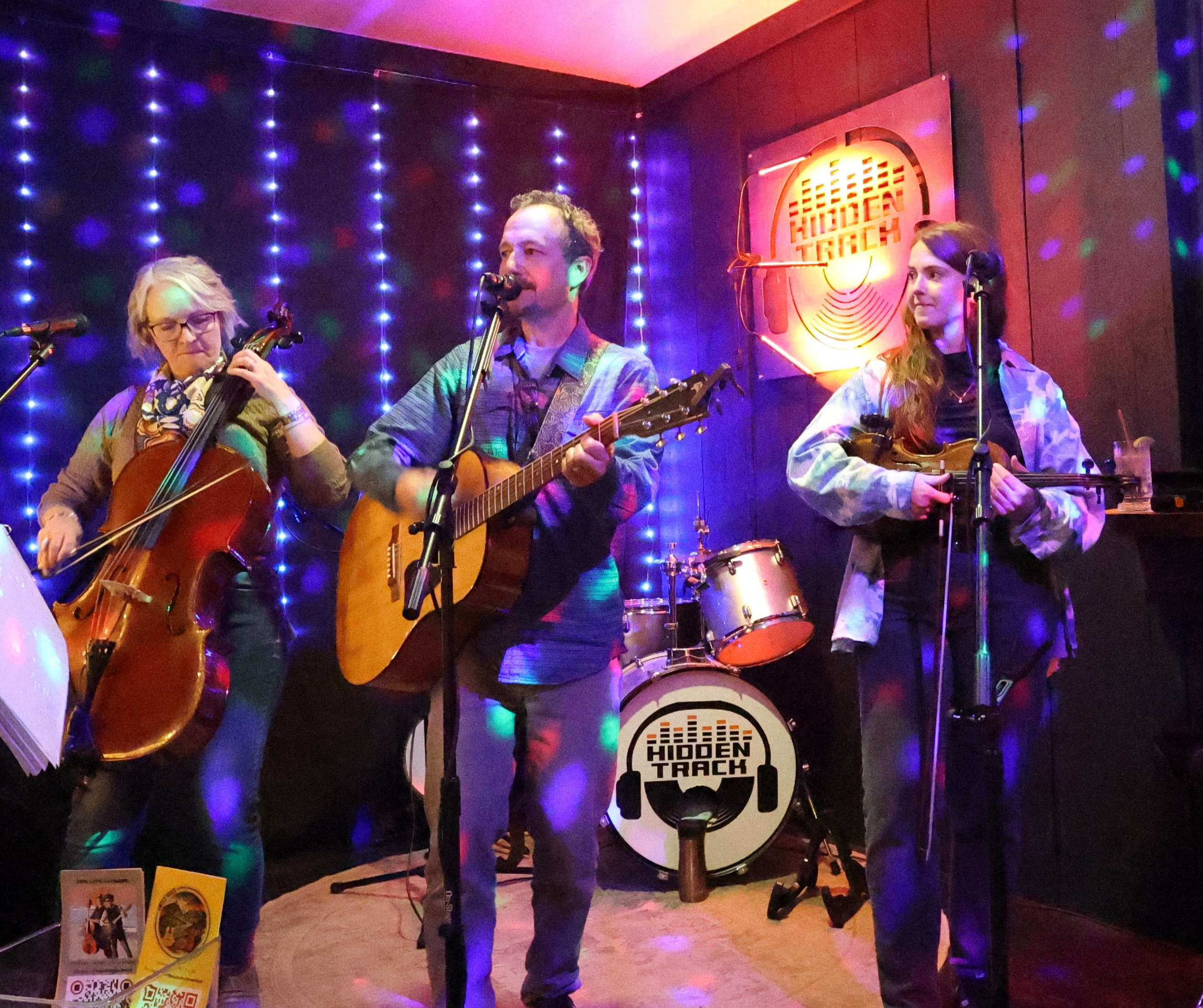 a group of people playing instruments in a room