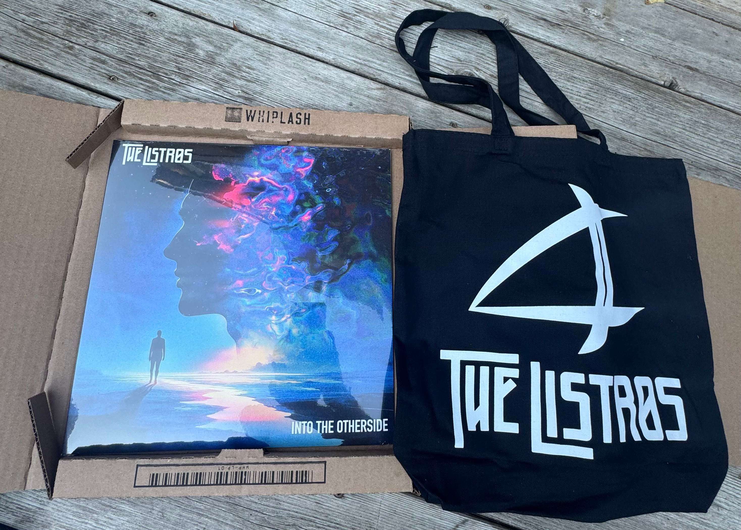 a tote bag with a poster and a book on it
