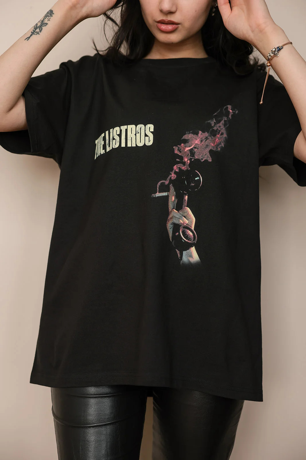 a woman wearing a black t - shirt with a flower on it