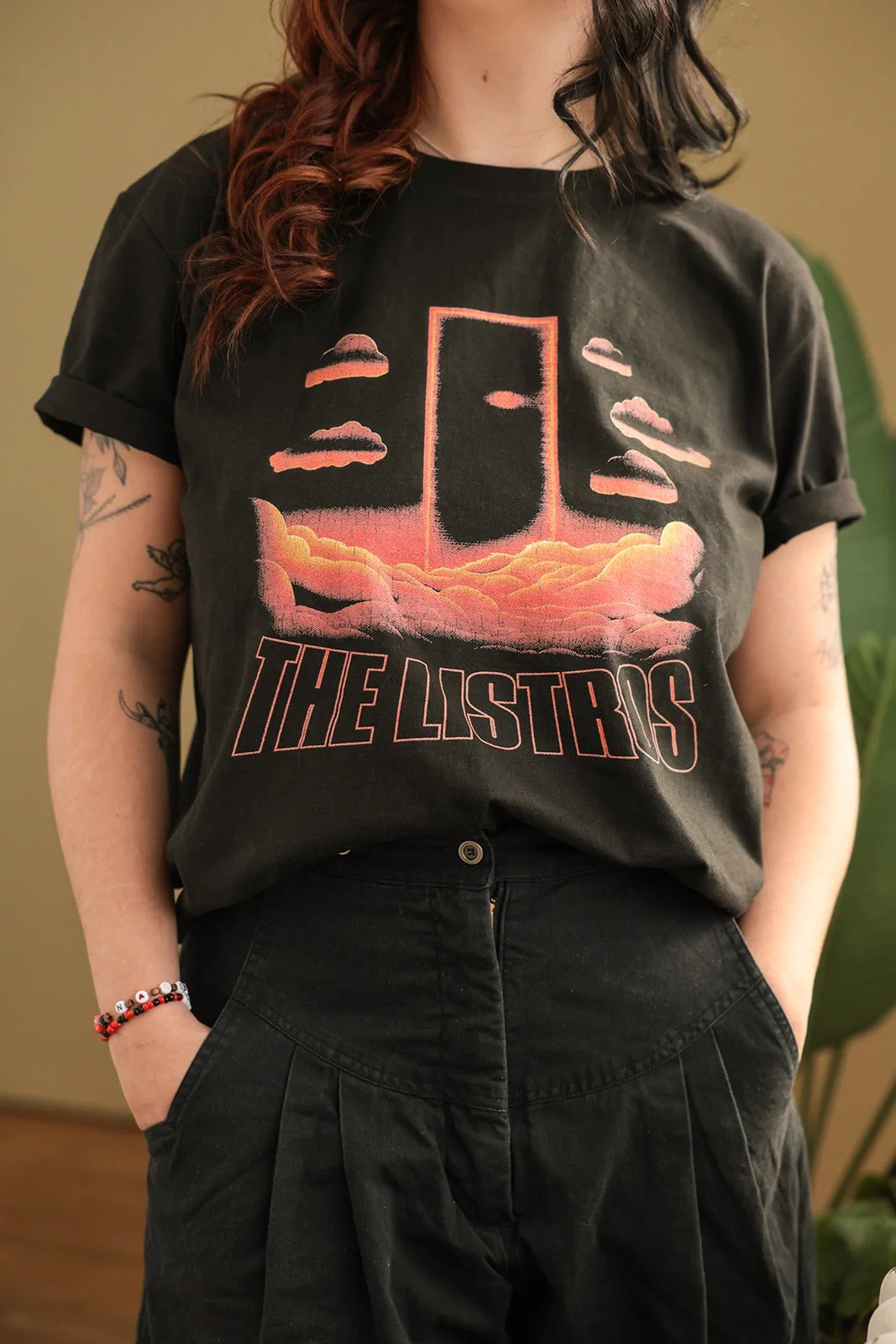 a woman wearing a black t - shirt that says the last supper