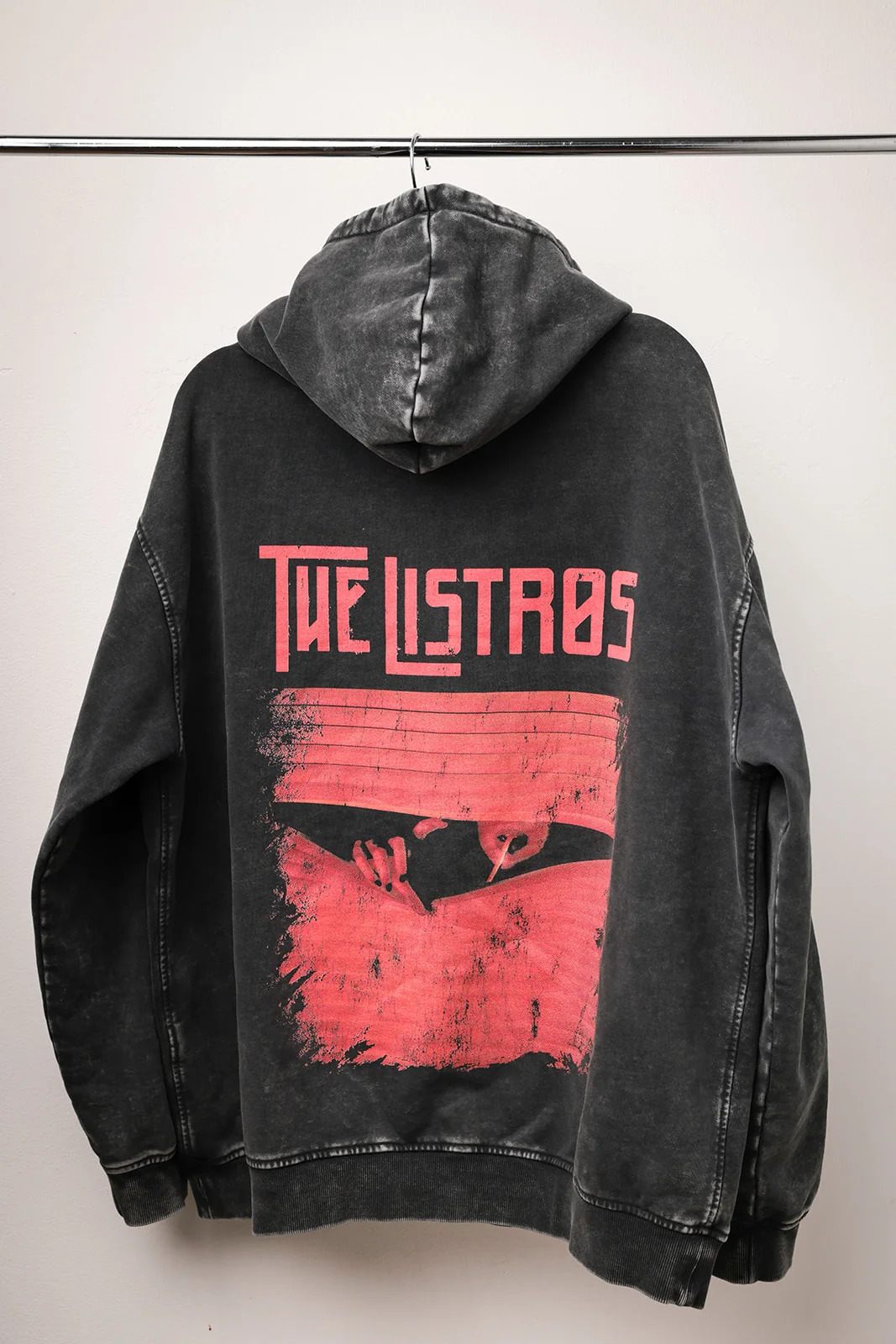 a black hoodie with an image of the listas on it