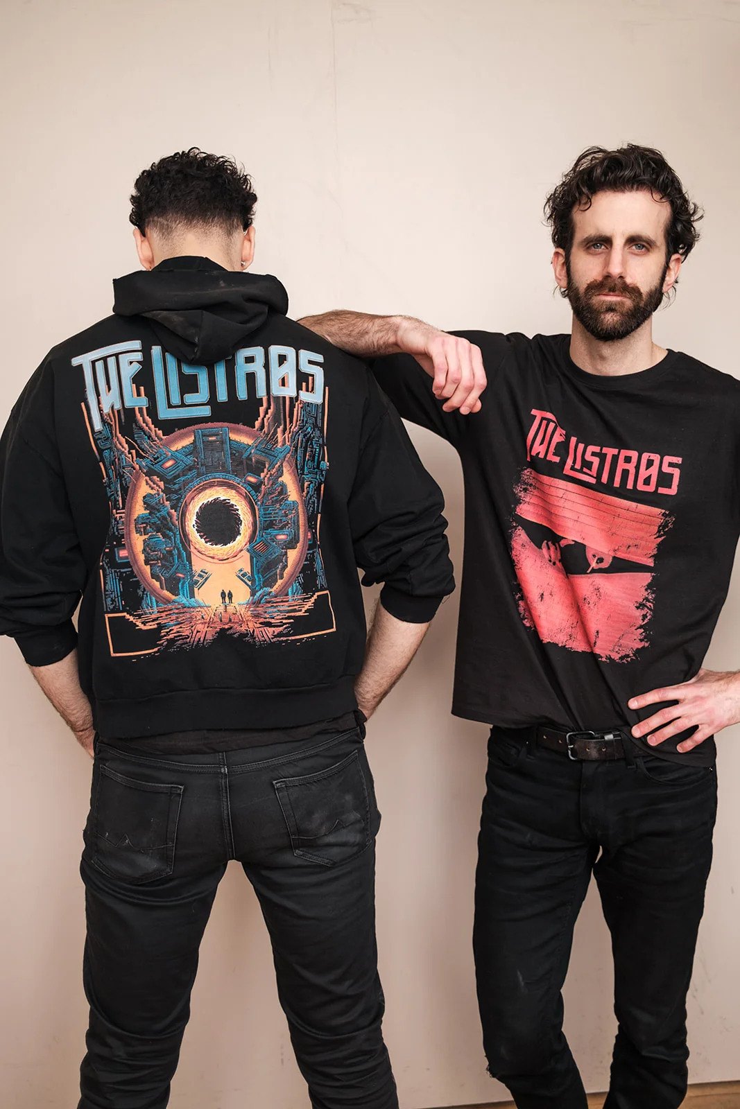 two men standing next to each other wearing t - shirts