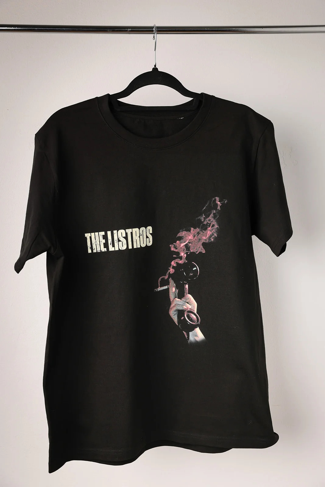 a black t - shirt with the words the lests on it