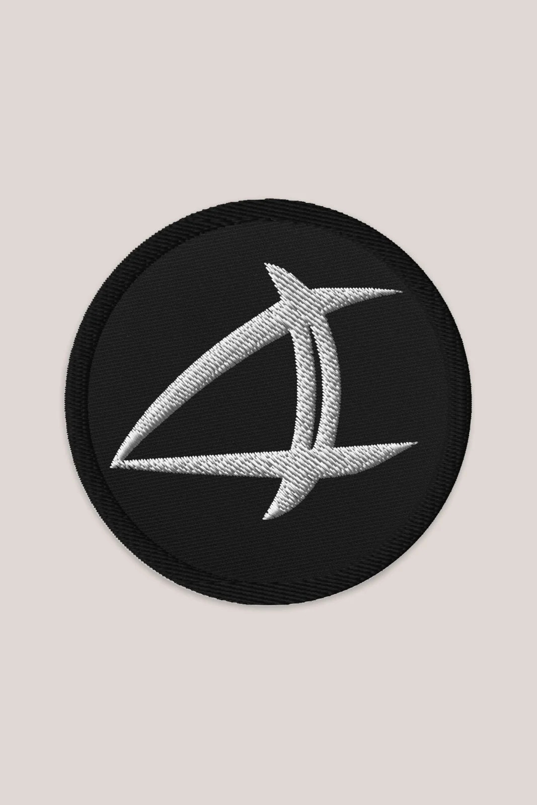 a black oval patch with a white arrow on it
