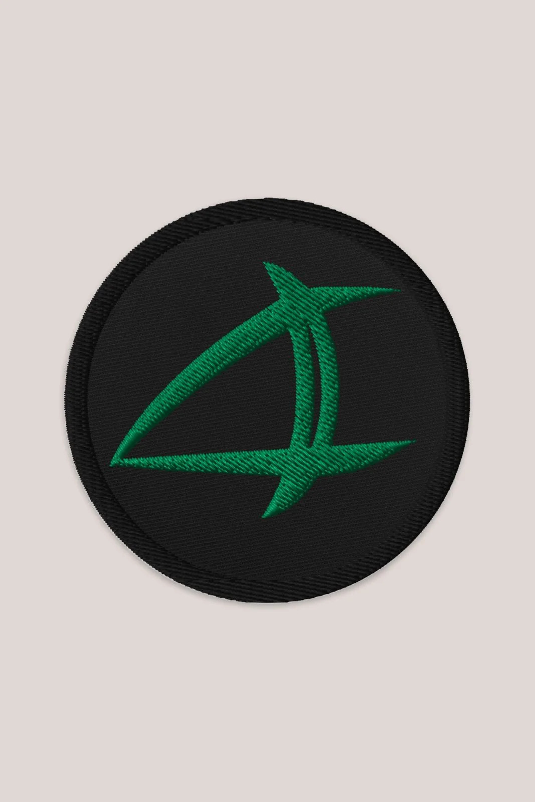 a black patch with a green arrow on it