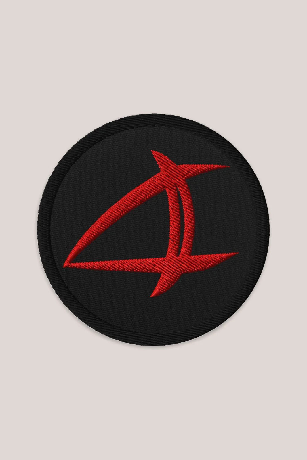 a black patch with a red arrow on it