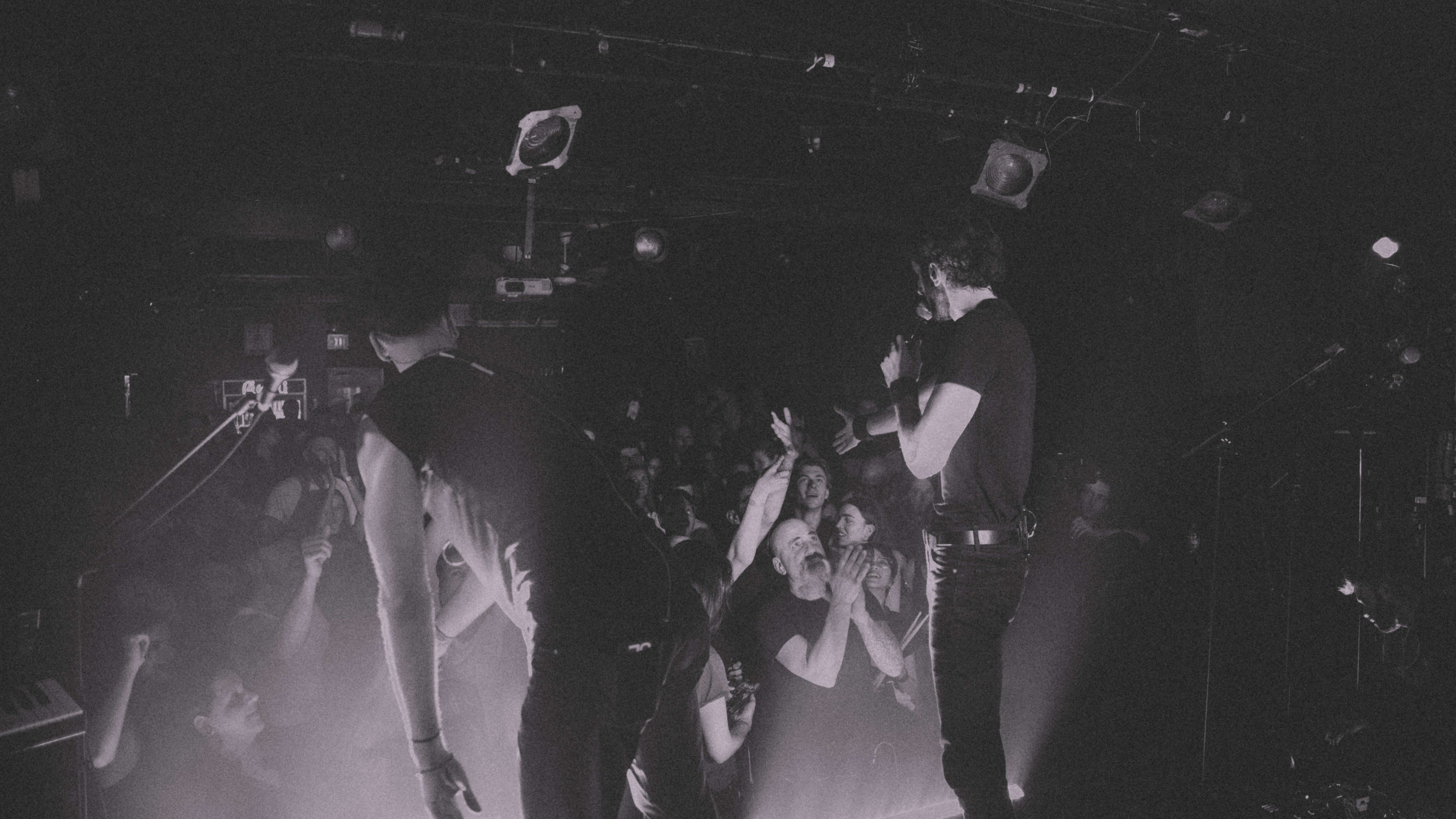a black and white photo of a band on stage