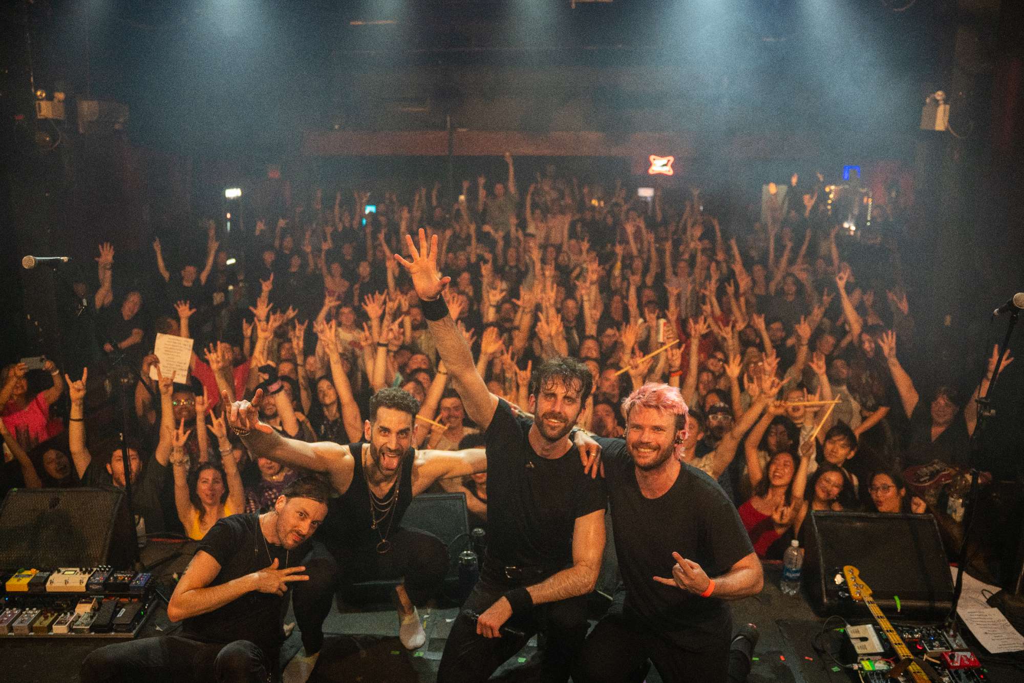 a group of people posing in front of a crowd