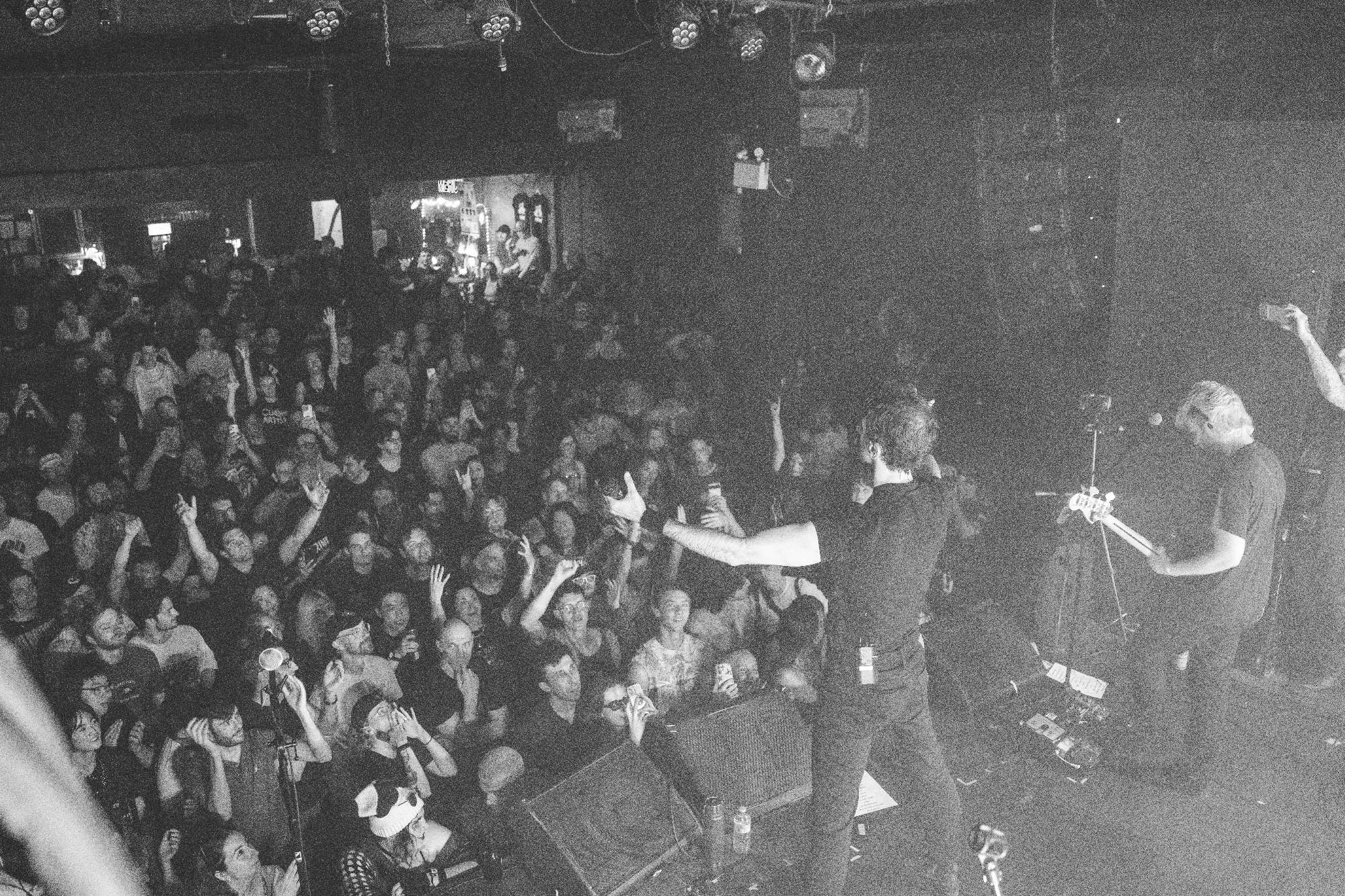 a black and white photo of a crowd at a concert