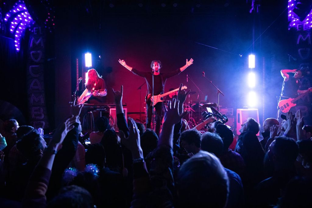 a group of people on stage at a concert
