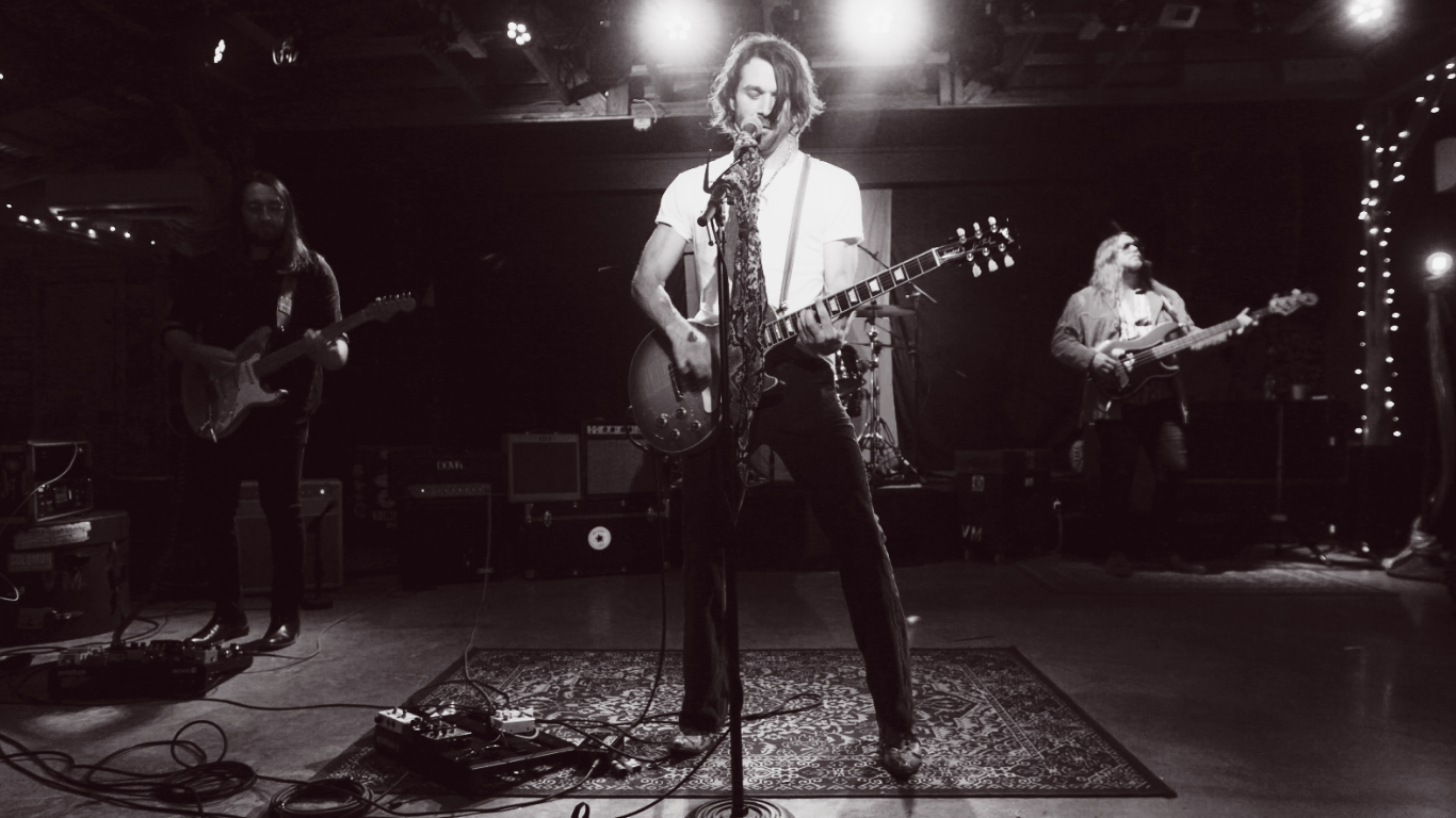a black and white photo of a group of people playing music