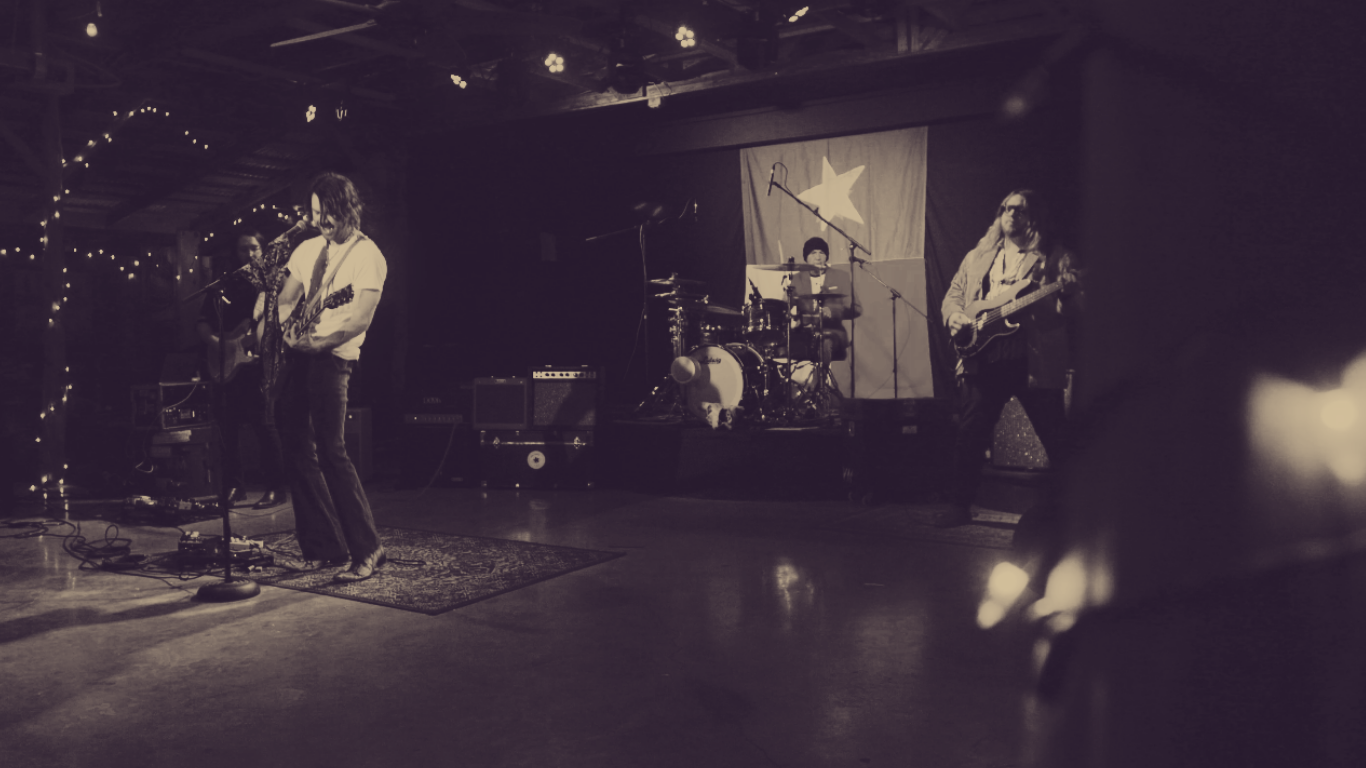 a black and white photo of a band on stage