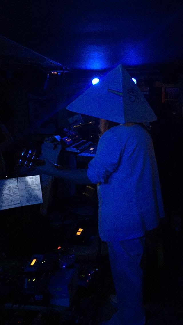 a person wearing a white hat in a dark room