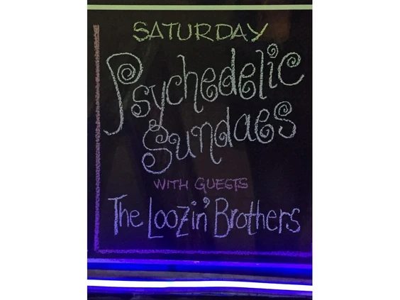 a sign that says psychedelic sazes with the loozd brothers