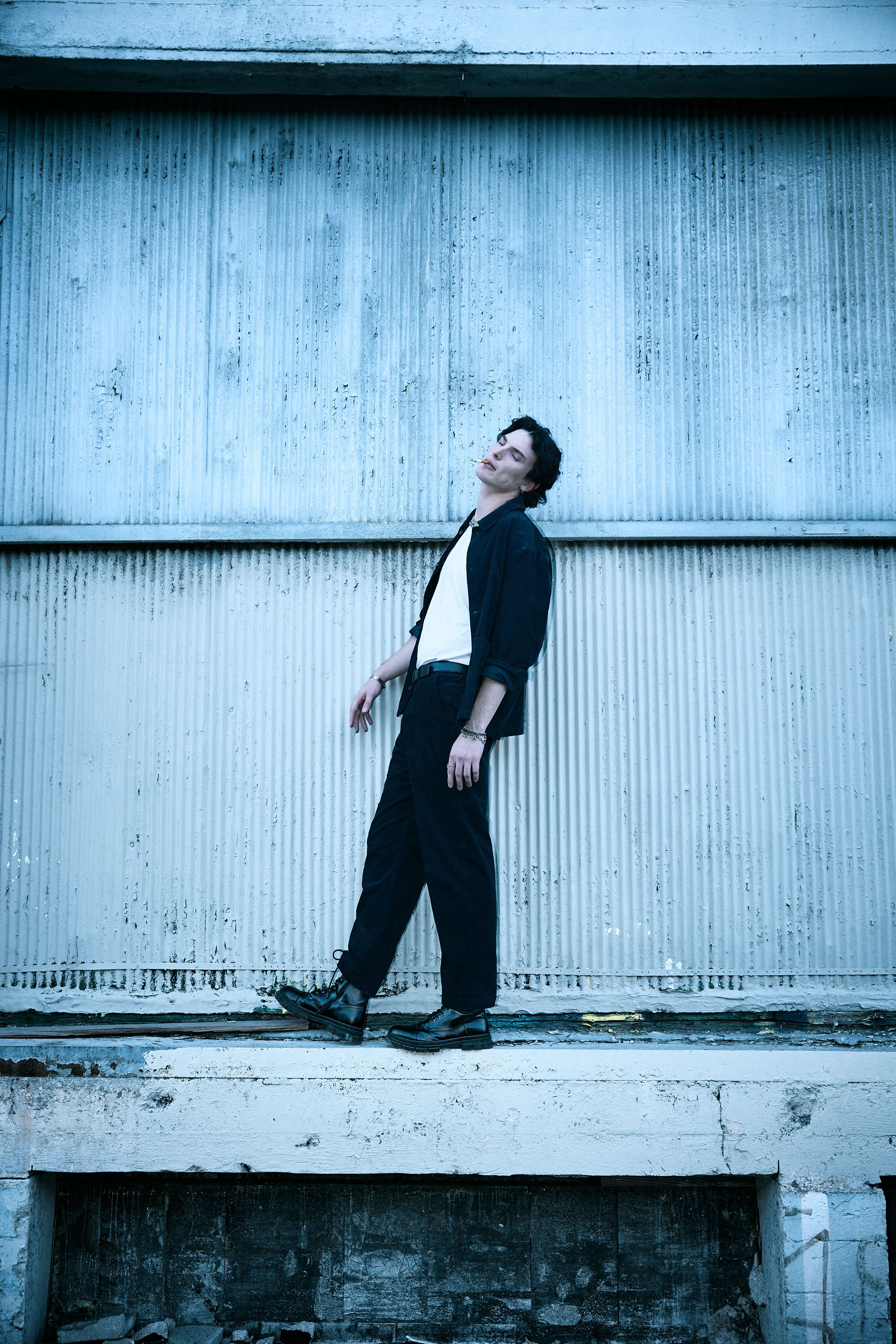 a man leaning against a wall