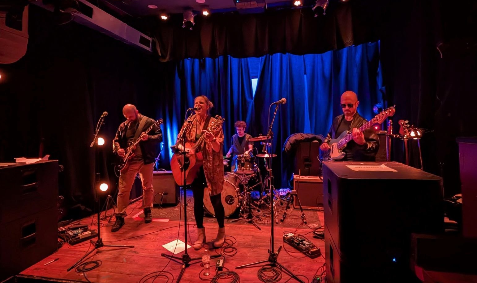 a group of people playing music in a dark room
