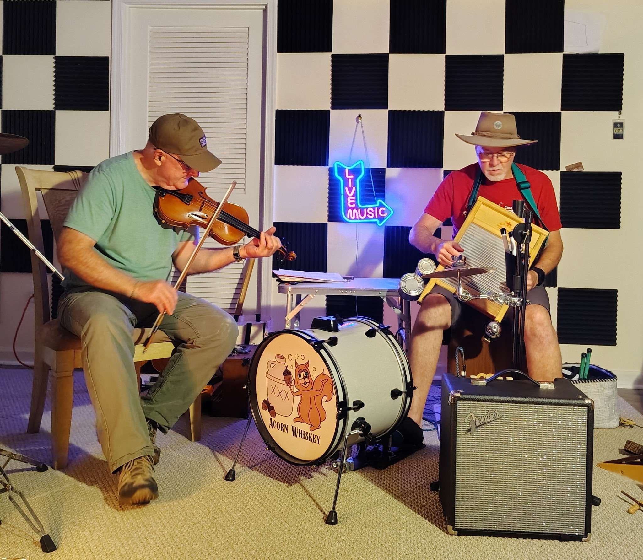 two men playing instruments in a room with a checkered floor