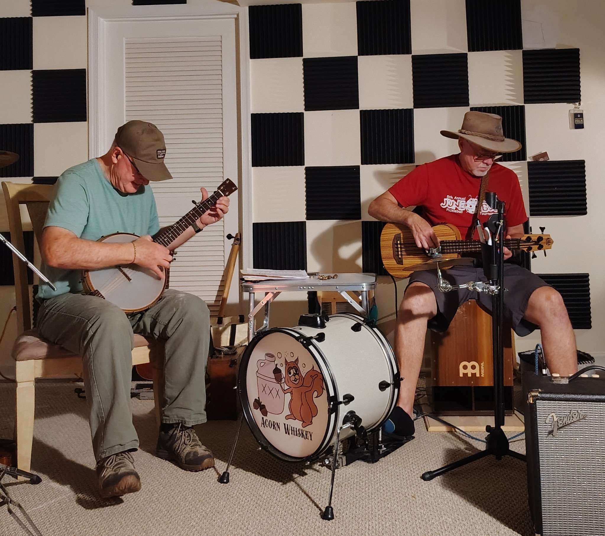 two men playing guitars in a recording studio