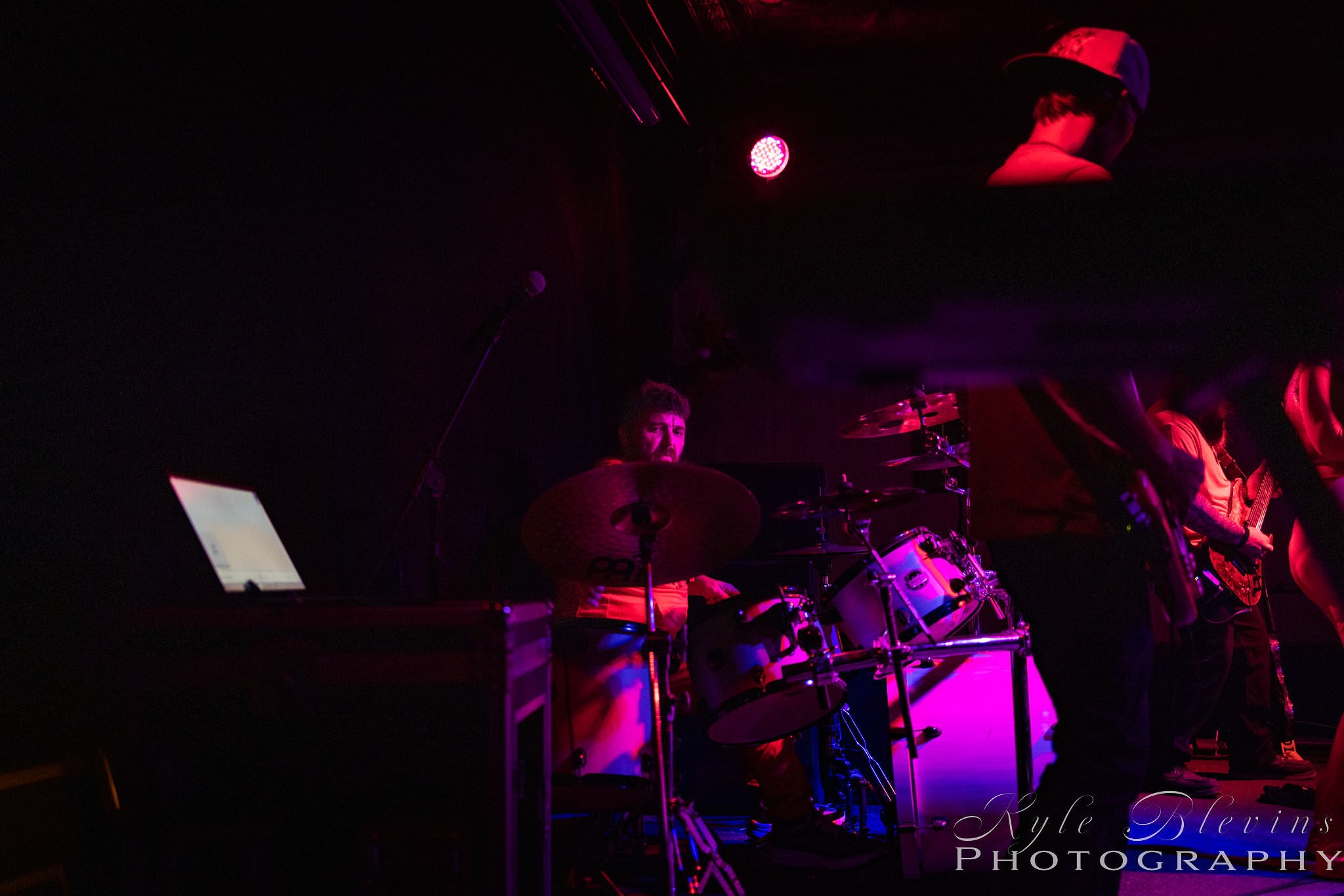 a group of people playing music in a dark room