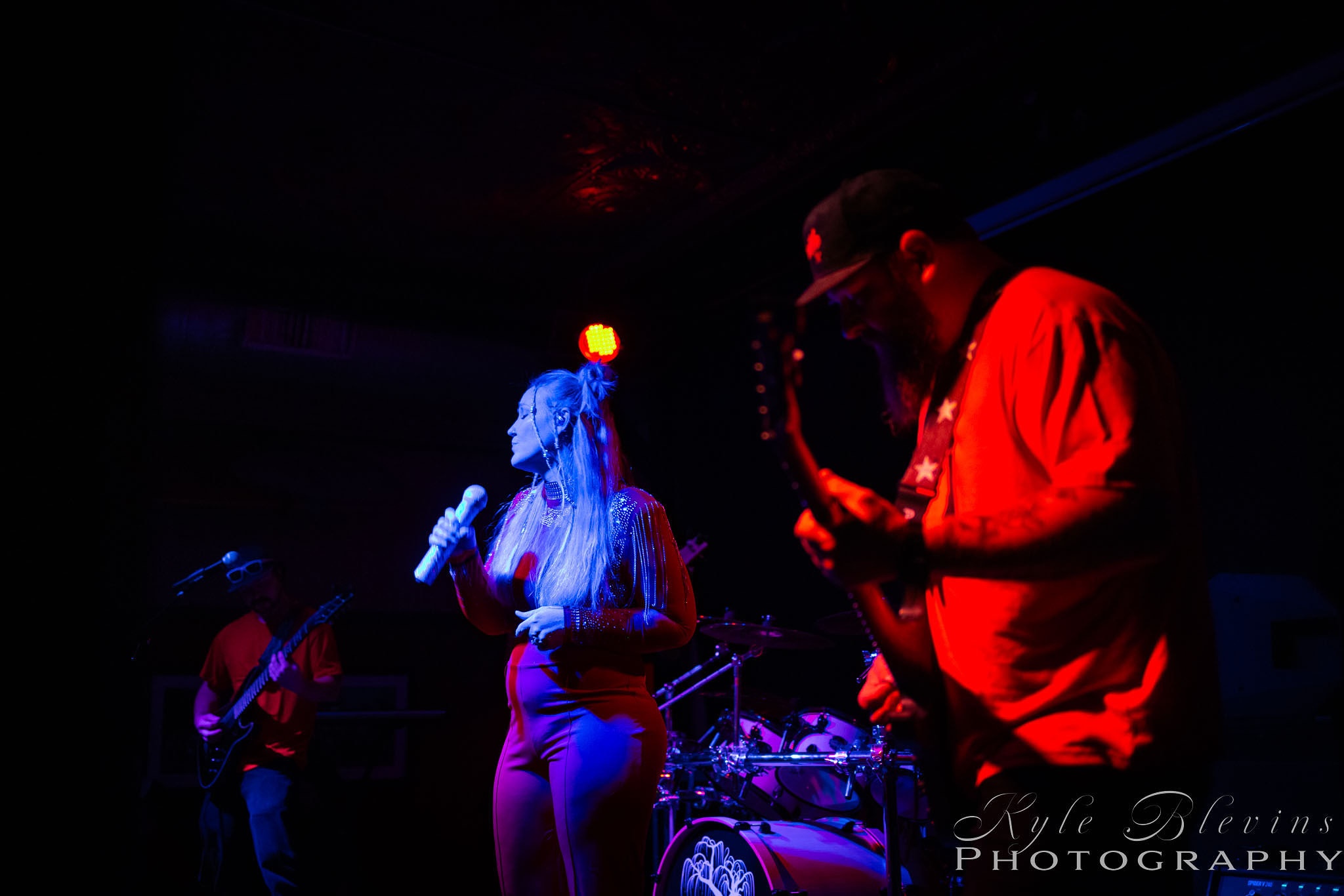a group of people playing music in a dark room