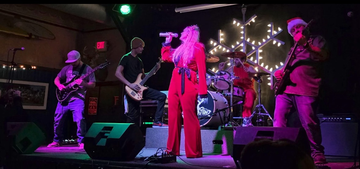 a group of people performing on stage at a nightclub