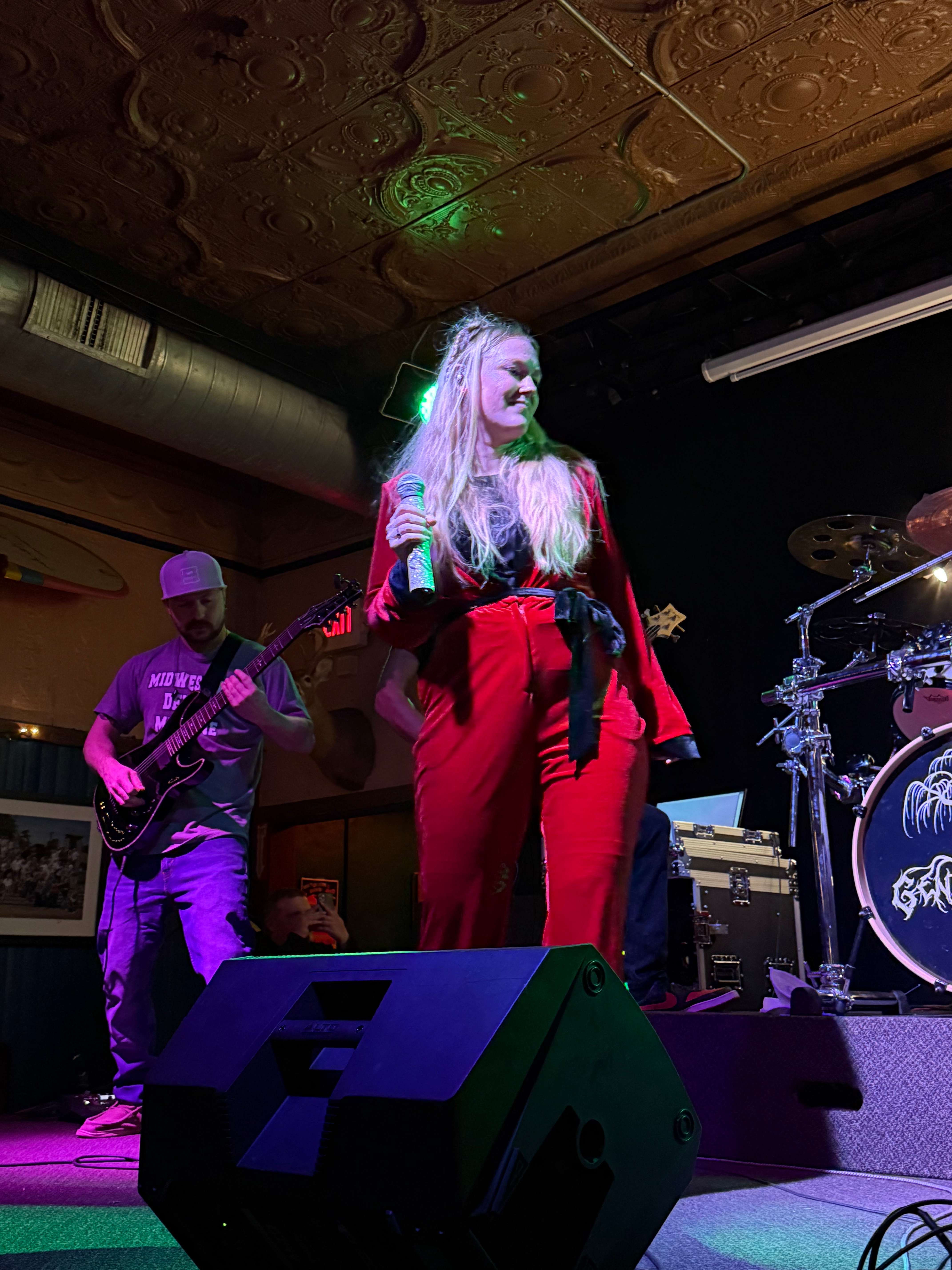 a woman on stage with a band